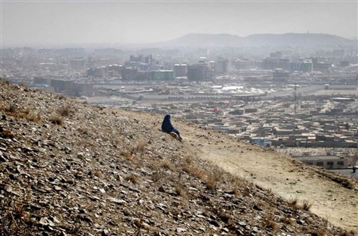 An Afghan woman clad in burqa watches the view of Kabul, Afghanistan on Wednesday, March 9, 2011. Insurgents killed more Afghan civilians last year than ever before and their roadside bombs, suicide attacks and assassinations were responsible for the overwhelming majority of conflict-related deaths in 2010, the United Nations said Wednesday. (AP Photo/Musadeq Sadeq) (AP)