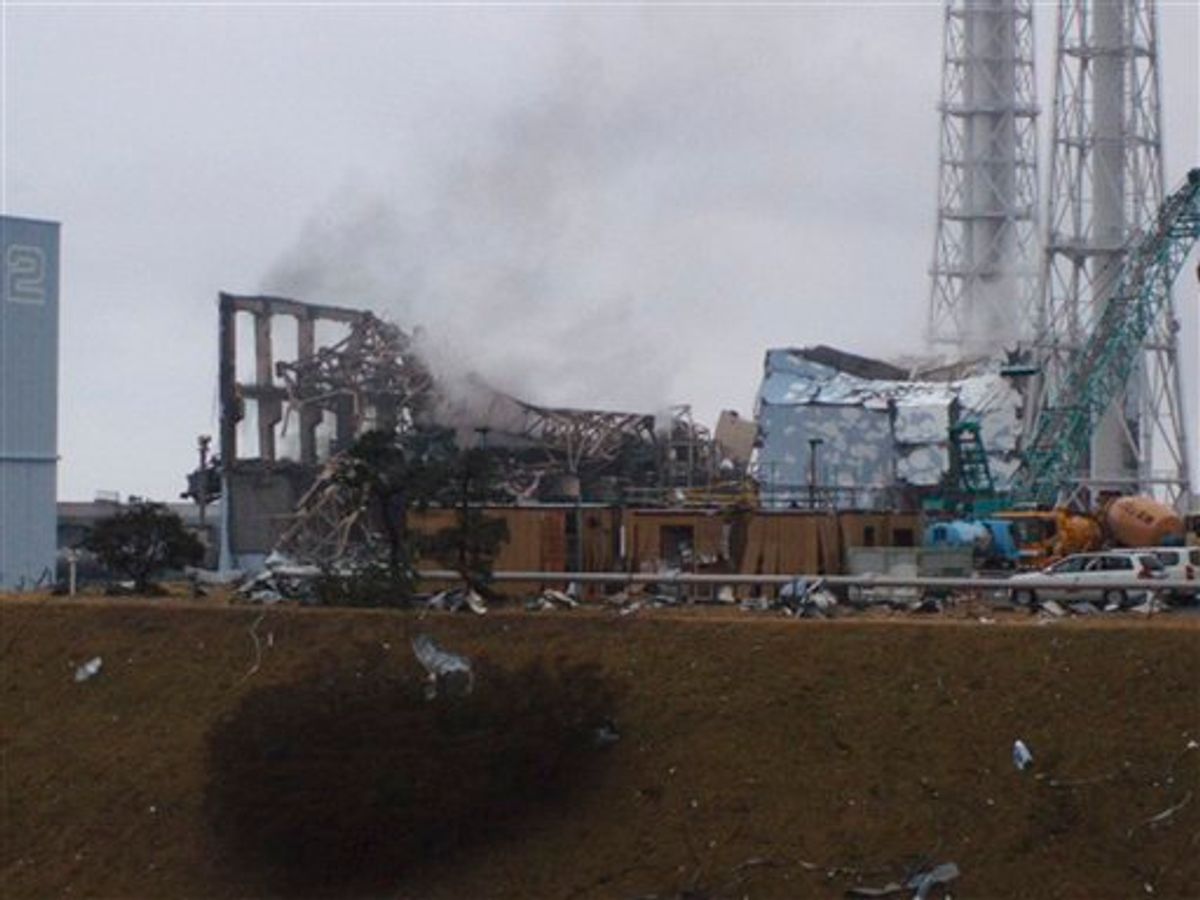 In this photo released by Tokyo Electric Power Co. (TEPCO), gray smoke rises from Unit 3 of the tsunami-stricken Fukushima Dai-ichi nuclear power plant in Okumamachi, Fukushima Prefecture, Japan, Monday, March 21, 2011. Official says the TEPCO temporarily evacuated its workers from the site. At left is Unit 2 and at right is Unit 4. (AP Photo/Tokyo Electric Power Co.) EDITORIAL USE ONLY (AP)