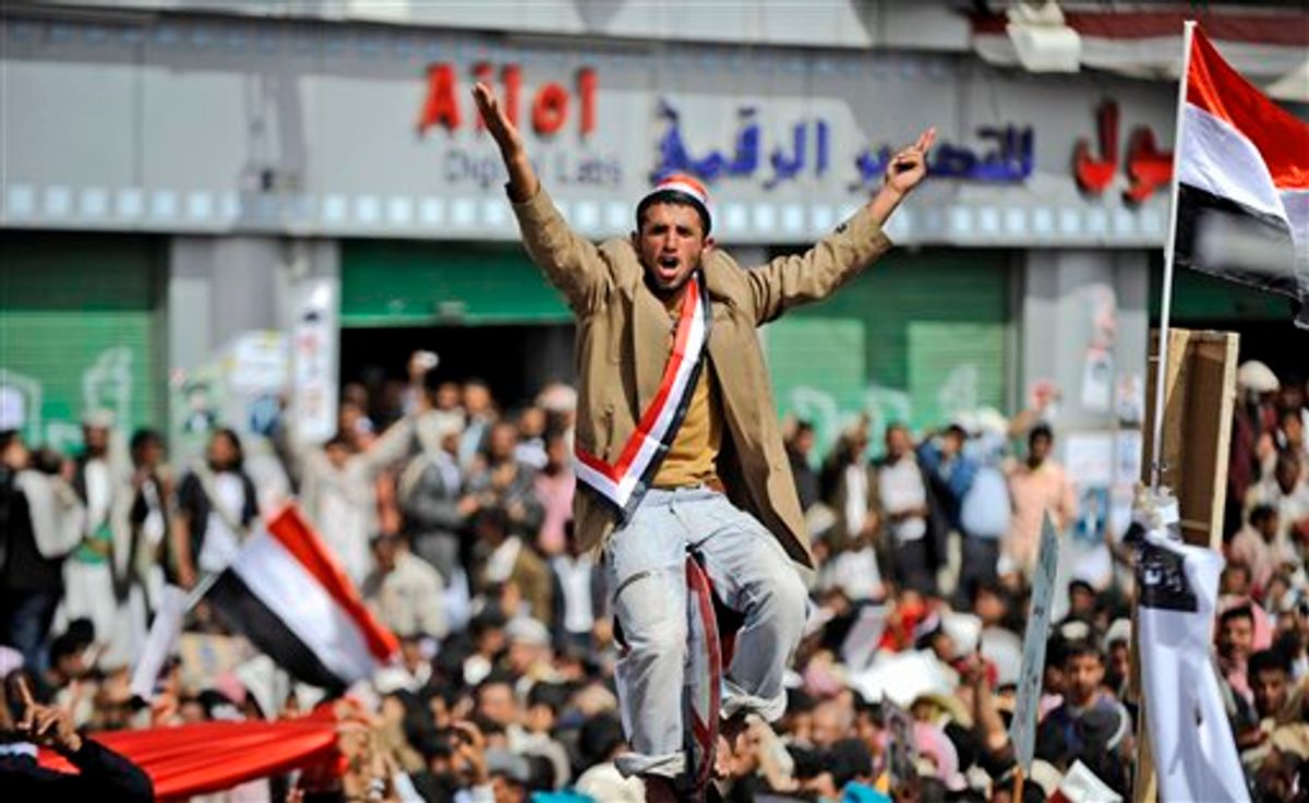 An anti-government protestor sitting on a traffic sign reacts as the bodies of  demonstrators who were killed on Friday's clashes with Yemeni security forces, arrive during their funeral procession in Sanaa,Yemen, Sunday, March 20, 2011. The Yemeni president's own tribe has called on him to step down after a deadly crackdown on protesters, robbing the embattled U.S.-backed leader of vital support in a society dominated by blood ties. (AP Photo/Hani Mohammed) (AP)