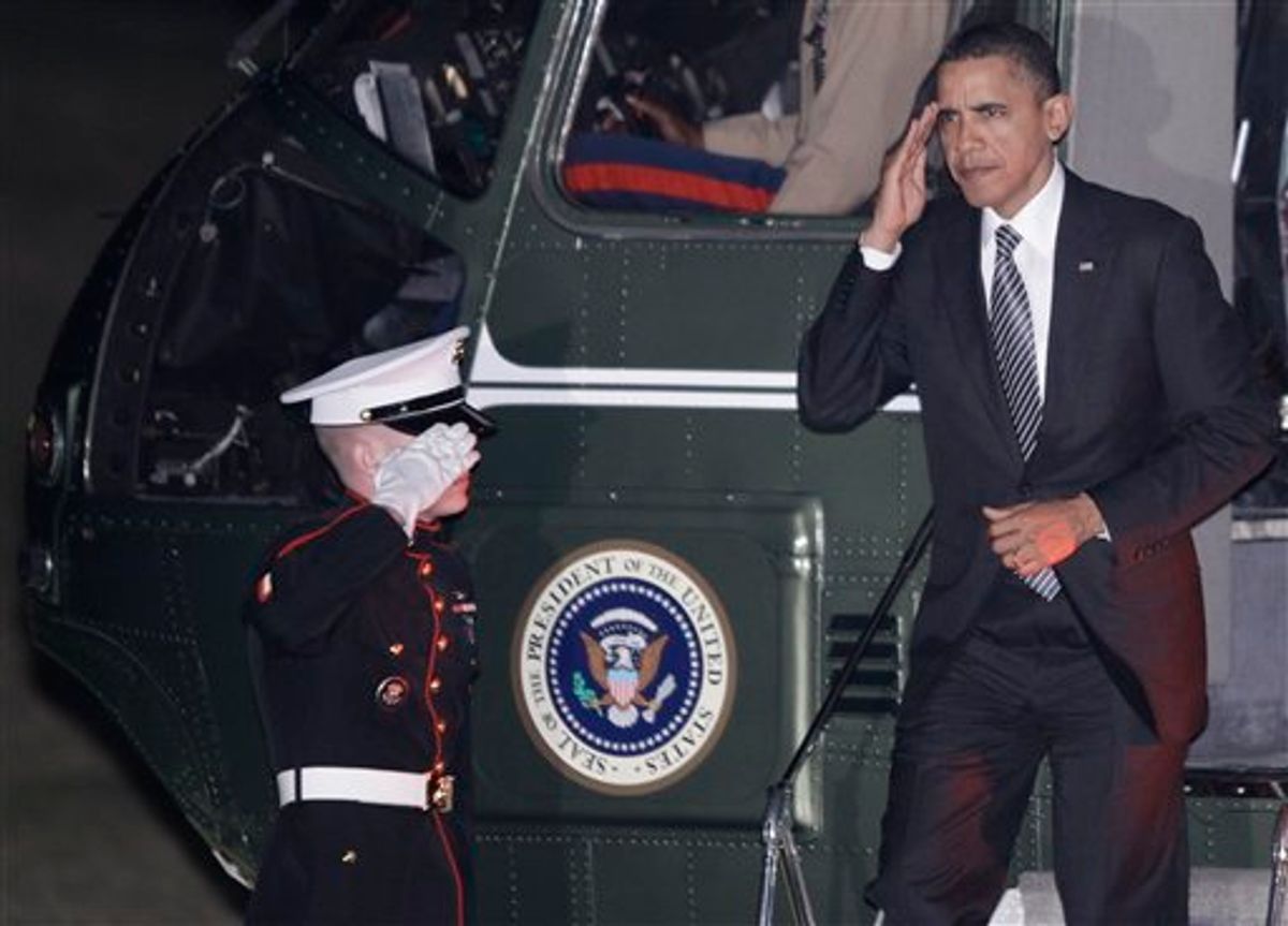President Barack Obama returns a Marine honor guard salute as he steps off Marine One upon returning to the White House in Washington, Tuesday, March 8, 2011, after traveling to education and fundraising events in Boston. (AP Photo/Charles Dharapak) (AP)