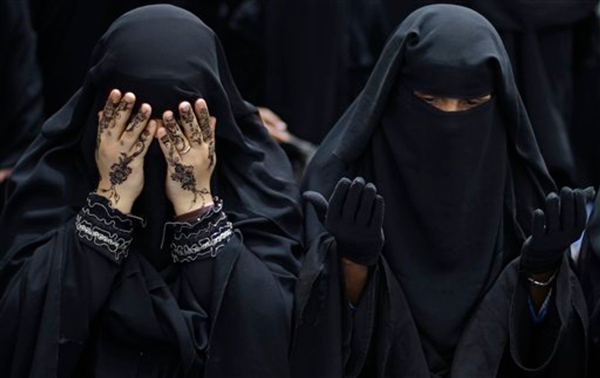 Female anti-government protestors react while chanting prayers during a demonstration demanding the resignation of Yemeni President Ali Abdullah Saleh, in Sanaa,Yemen, Sunday, March 27, 2011. Islamic militants seized control of a weapons factory and a nearby town in Yemen's south Sunday, said a witness and security officials, as political turmoil around the country causes security to unravel. (AP Photo/Muhammed Muheisen) (AP)