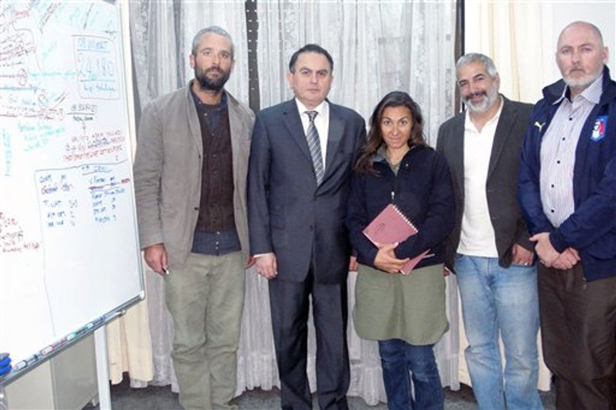 In this March 21, 2011 photo released by the  Turkish Ministry of Foreign Affairs, from left to right, New York Times journalists Tyler Hicks, T Ambassdor Levent Sahinkaya, Lynsey Addario  Anthony Shadid and Stephen Farrell  pose at the Turkish Embassy in Tripoli, Libya. The four New York Times journalists who had been held by Libya crossed into Tunisia on Monday after being released. (AP Photo/Turkish Ministry of Foreign Affairs) (AP)