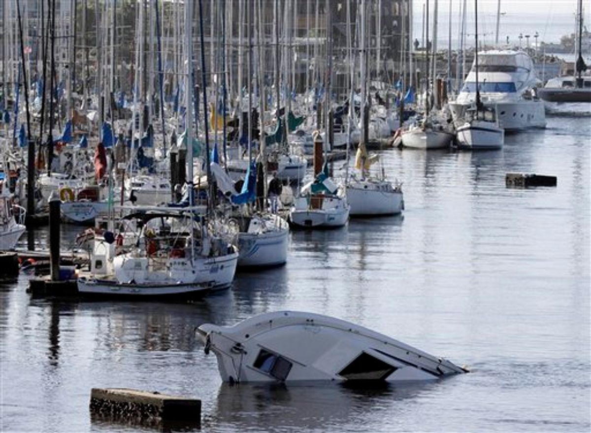 A boat sinks into the ocean in the aftermath of the surge caused by a tsunami on the harbor in Santa Cruz, Calif., Friday, March 11, 2011. A ferocious tsunami unleashed by Japan's biggest recorded earthquake slammed into its eastern coast Friday, killing hundreds of people as it carried away ships, cars and homes, and triggered widespread fires that burned out of control. Hours later, the waves washed ashore on Hawaii and the U.S. West coast, where evacuations were ordered from California to Washington but little damage was reported. The entire Pacific had been put on alert _ including coastal areas of South America, Canada and Alaska _ but waves were not as bad as expected. (AP Photo/Marcio Jose Sanchez) (AP)