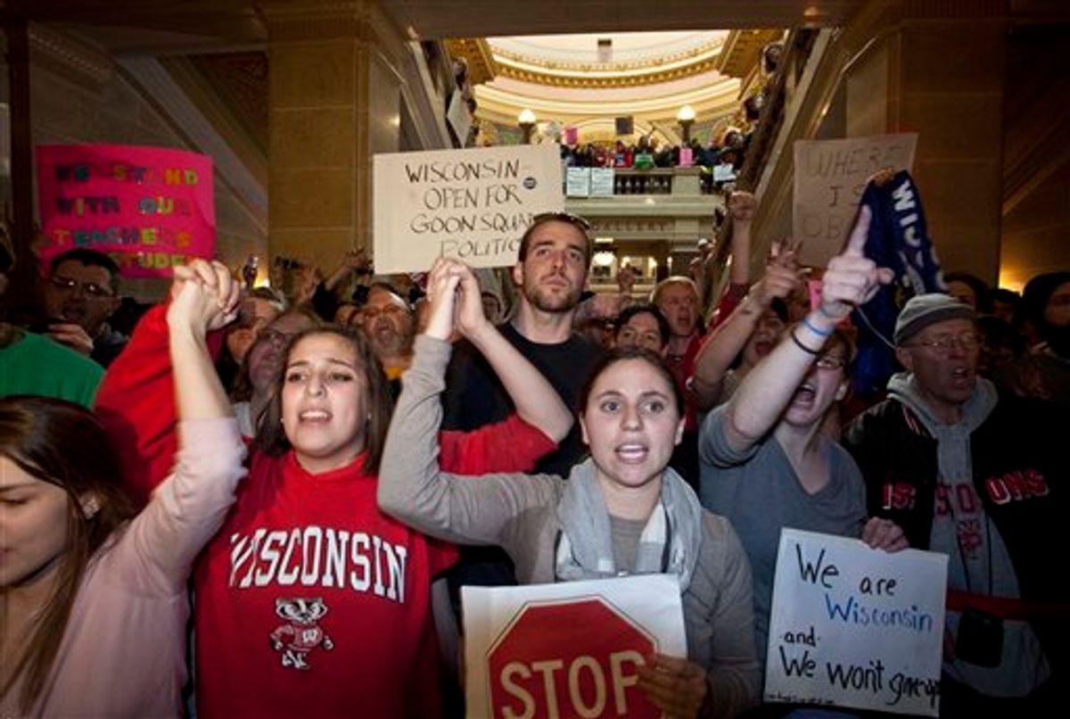Protesters yell outside Wisconsin Gov. Scott Walker offivce after a ceremonial bill signing ceremony Friday, March 11, 2011, in Madison, Wis. (AP Photo/Morry Gash) (AP)