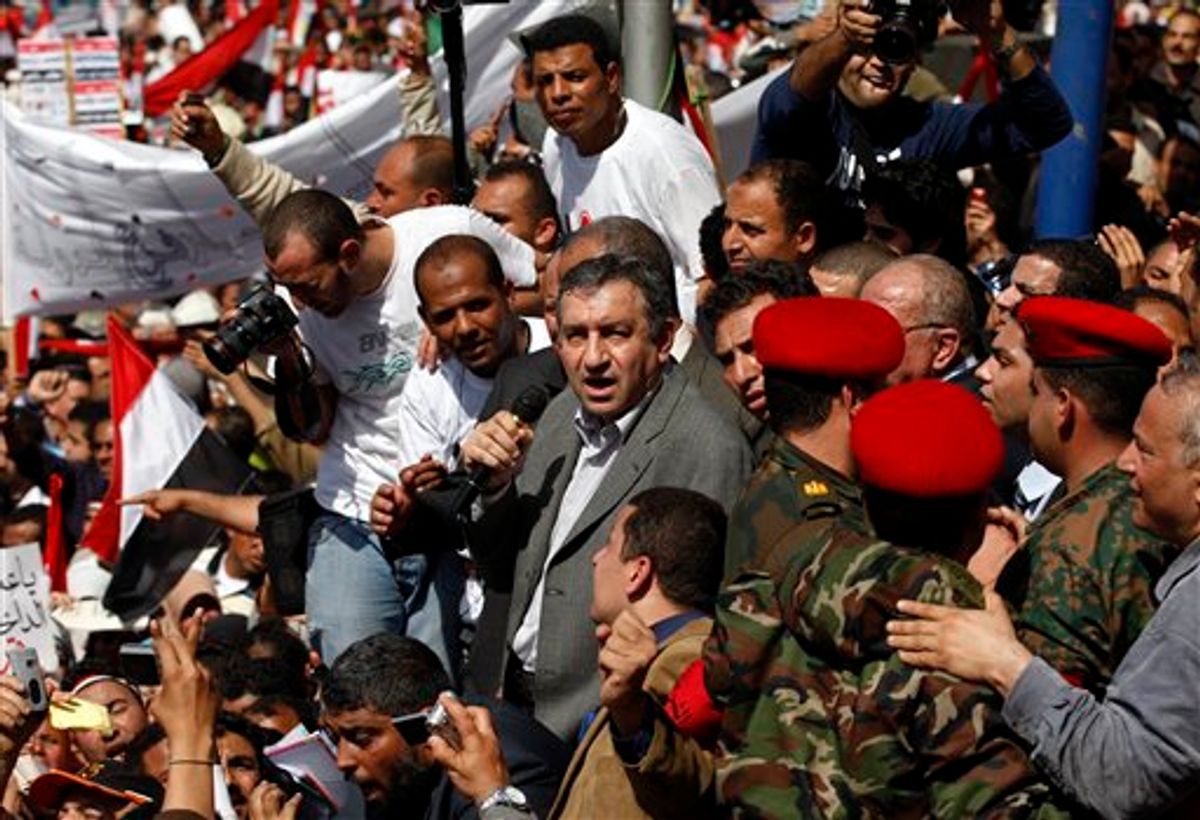 Egypt's new Prime Minister designate Essam Sharaf is surrounded by supporters as he gives a speech at the Tahrir Square in Cairo, Egypt, Friday, March 4, 2011. Sharaf vowed before thousands of mostly young demonstrators at the central Cairo square to do everything he could to meet their demands and pleaded for them to turn their attention to "rebuilding" the country. Sharaf was picked by Egypt's ruling military on Thursday march 3, to replace Ahmed Shafiq as prime minister. (AP Photo/Khalil Hamra) (AP)