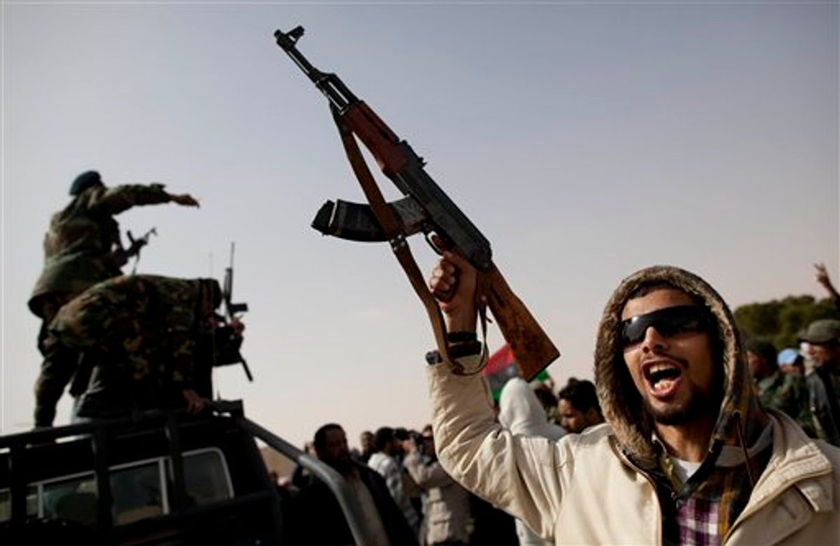 Libyan rebels who are part of the forces against Libyan leader Moammar Gadhafi celebrate after capturing the oil town of Ras Lanuf, in eastern Libya, Saturday, March 5, 2011. Witnesses say Libyan rebels have captured the oil port town of Ras Lanouf from pro-Moammar Gadhafi forces, their first military victory in what could be a long, westward march to the capital Tripoli. The witnesses said on Saturday that Ras Lanouf, about 87 miles (140 kilometers) east of the Gadhafi stronghold of Sirte, fell in rebel hands Friday night after a fierce battle with pro-regime forces who later fled. (AP Photo/Kevin Frayer) (AP)