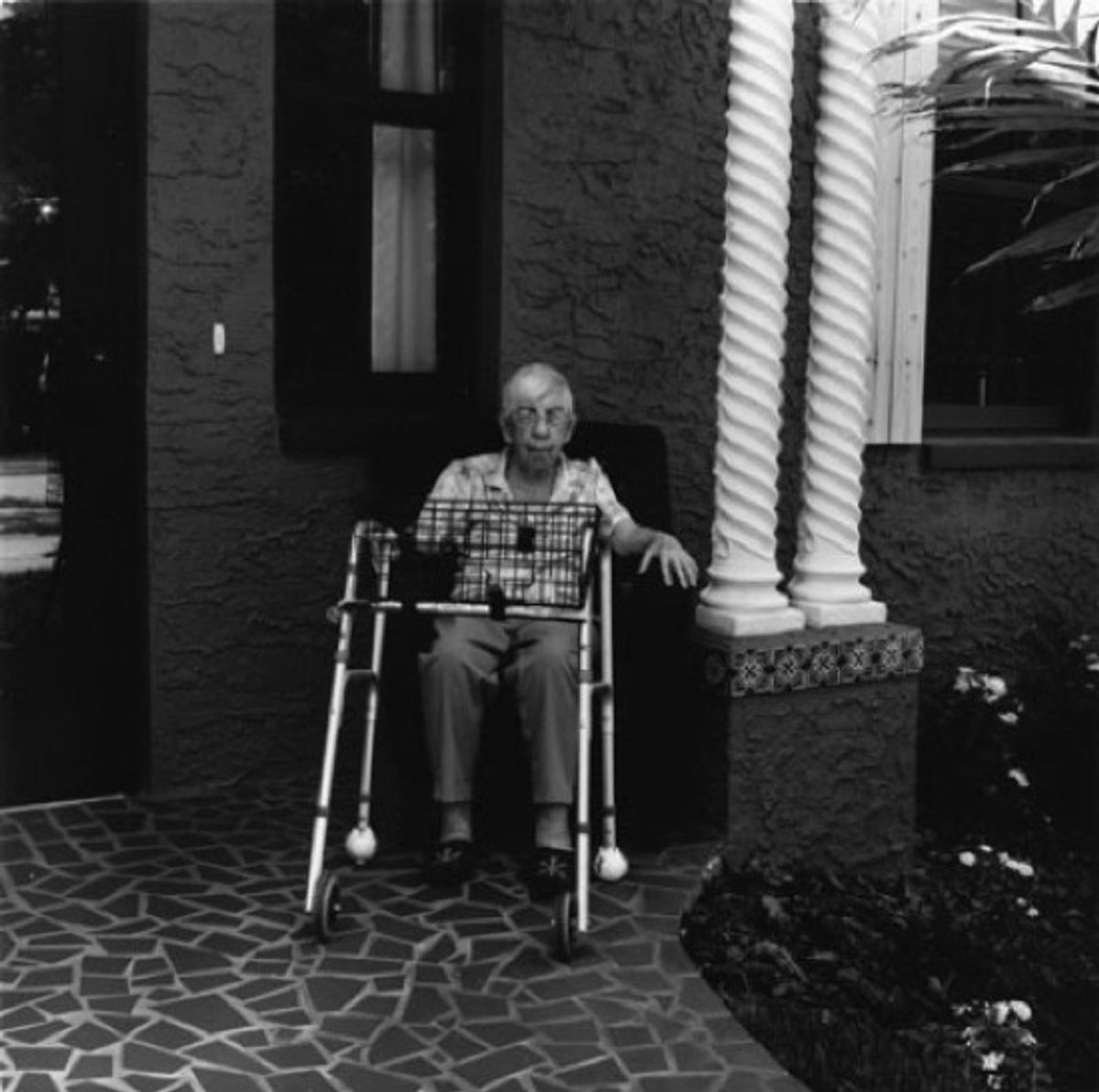 A woman sits outside a nursing home in old Merritt Island, Florida.  