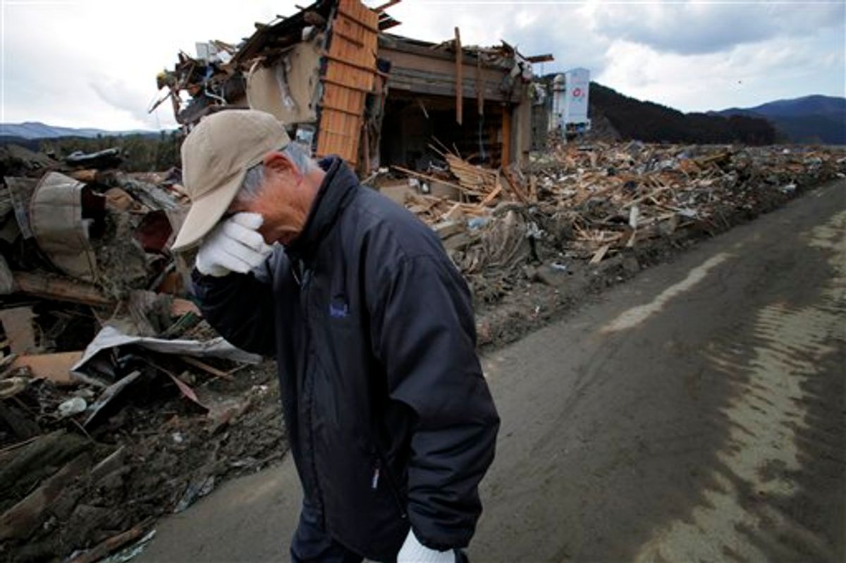 CORRECTS SPELLING OF SISTER-IN-LAW - Katsuo Maiya, 73, cries in front of the rubble where his sister-in-law's house stood in Rikuzentakata, Iwate Prefecture, northern Japan, Thursday, March 17, 2011. Maiya's sister-in-law and her husband were killed in Friday's earthquake and tsunami. (AP Photo/Itsuo Inouye) (AP)