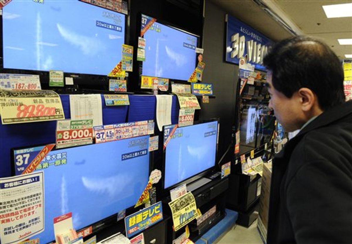 A man watches TV showing a Japanese military helicopter dumping water on the troubled reactors of the Fukushima Dai-ichi complex, at an electronics retail store in Osaka, western Japan, on Thursday, March 17, 2011. (AP Photo/Kyodo News) JAPAN OUT, MANDATORY CREDIT, NO LICENSING IN CHINA, HONG KONG, JAPAN, SOUTH KOREA AND FRANCE (AP)
