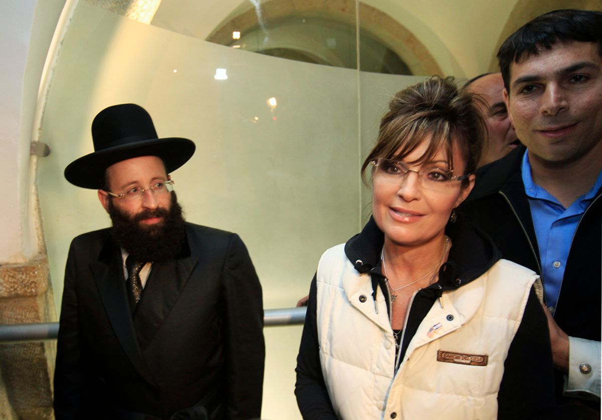 Former Alaska governor Sarah Palin is escorted by Western Wall Rabbi Shmuel Rabinovitz (L) and Israeli lawmaker Danny Danon (R) as she leaves the Western Wall tunnels in Jerusalem's Old City March 20, 2011. Palin began a private visit to Israel on Sunday, her first to the Jewish state, and planned to meet Prime Minister Benjamin Netanyahu and tour holy sites. Israeli media described her trip as a bid to show support for Israel, whose standing is strong among U.S. voters, and gain more experience in international affairs ahead of a possible presidential run. REUTERS/Ronen Zvulun (JERUSALEM - Tags: POLITICS RELIGION)   (Â© Ronen Zvulun / Reuters)