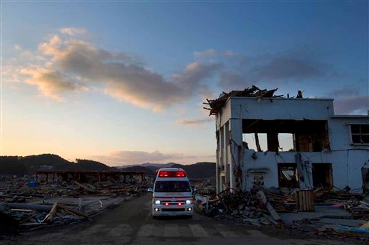 A Japanese ambulance drives through the earthquake and tsunami-hit town of Minamisanriku, Friday, March 18, 2011.  (AP Photo/David Guttenfelder) (AP)