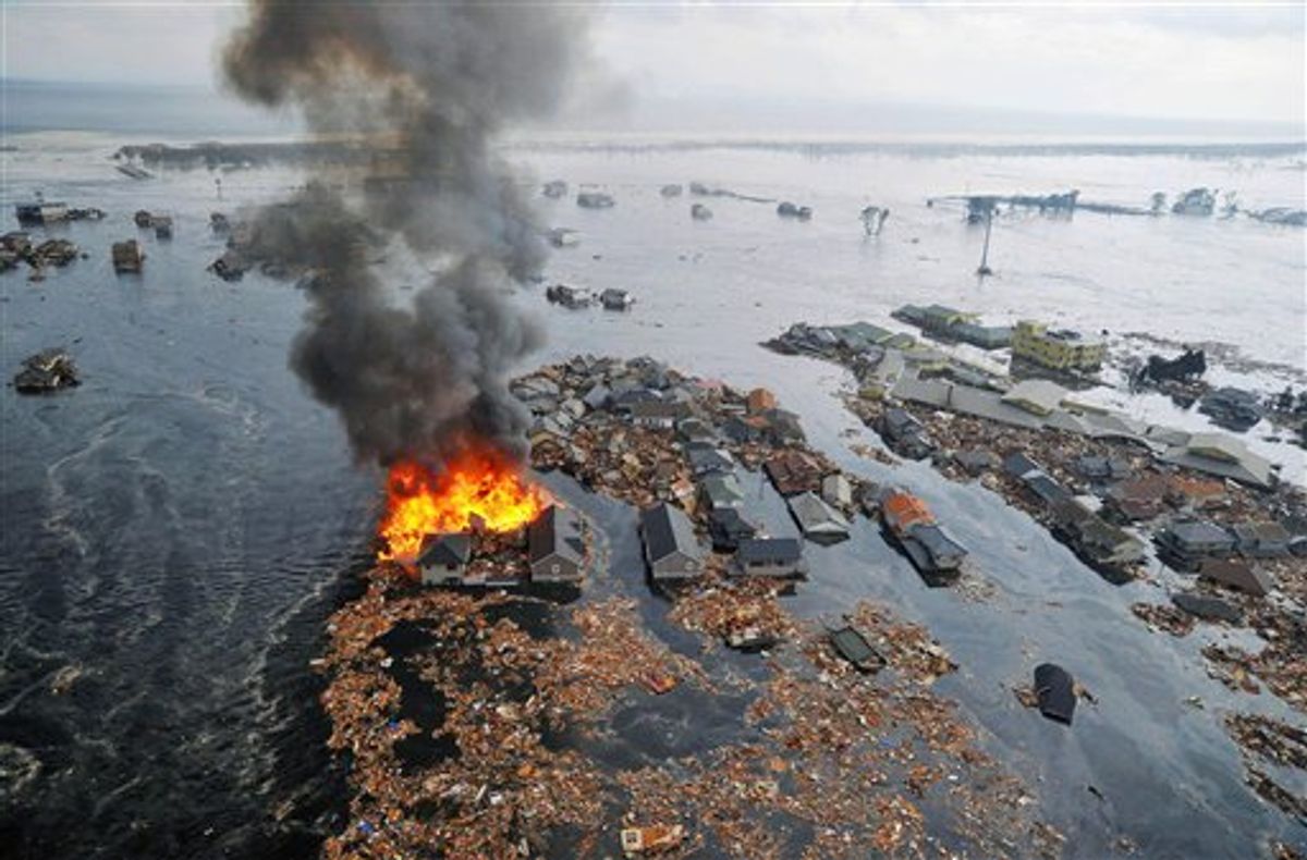 Houses swallowed by tsunami waves burn in Sendai, Miyagi Prefecture (state) after Japan was struck by a strong earthquake off its northeastern coast Friday, March 11, 2011. (AP Photo/Kyodo News) JAPAN OUT, MANDATORY CREDIT, FOR COMMERCIAL USE ONLY IN NORTH AMERICA, NO SALES (AP)