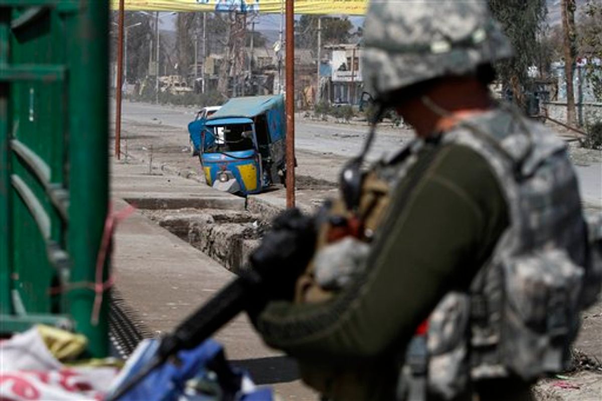 US solider stands guard near the site of explosion in Jalalabad, Afghanistan, Monday, March, 7, 2011. An Afghan Interior Ministry spokesman says a roadside bomb in the eastern city of Jalalabad has killed two policemen and wounded another 25 people.(AP Photo/Rahmat Gul) (AP)
