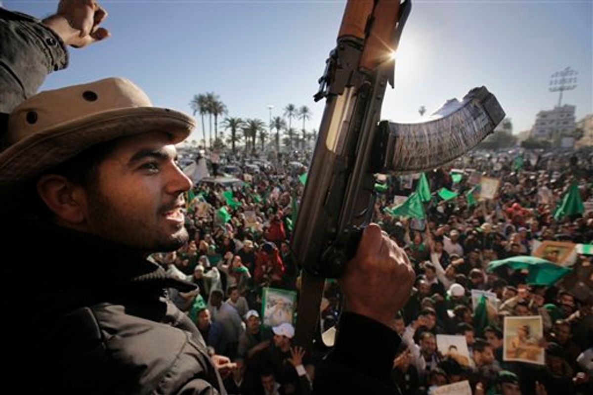 Pro-Gadhafi soldiers and supporters gather to celebrate in Green Square, Tripoli, Libya Sunday, March 6, 2011. Thousands of Moammar Gadhafi's supporters poured into the streets of Tripoli on Sunday morning, waving flags and firing their guns in the air in the Libyan leader's main stronghold, claiming overnight military successes. (AP Photo/Ben Curtis) (AP)