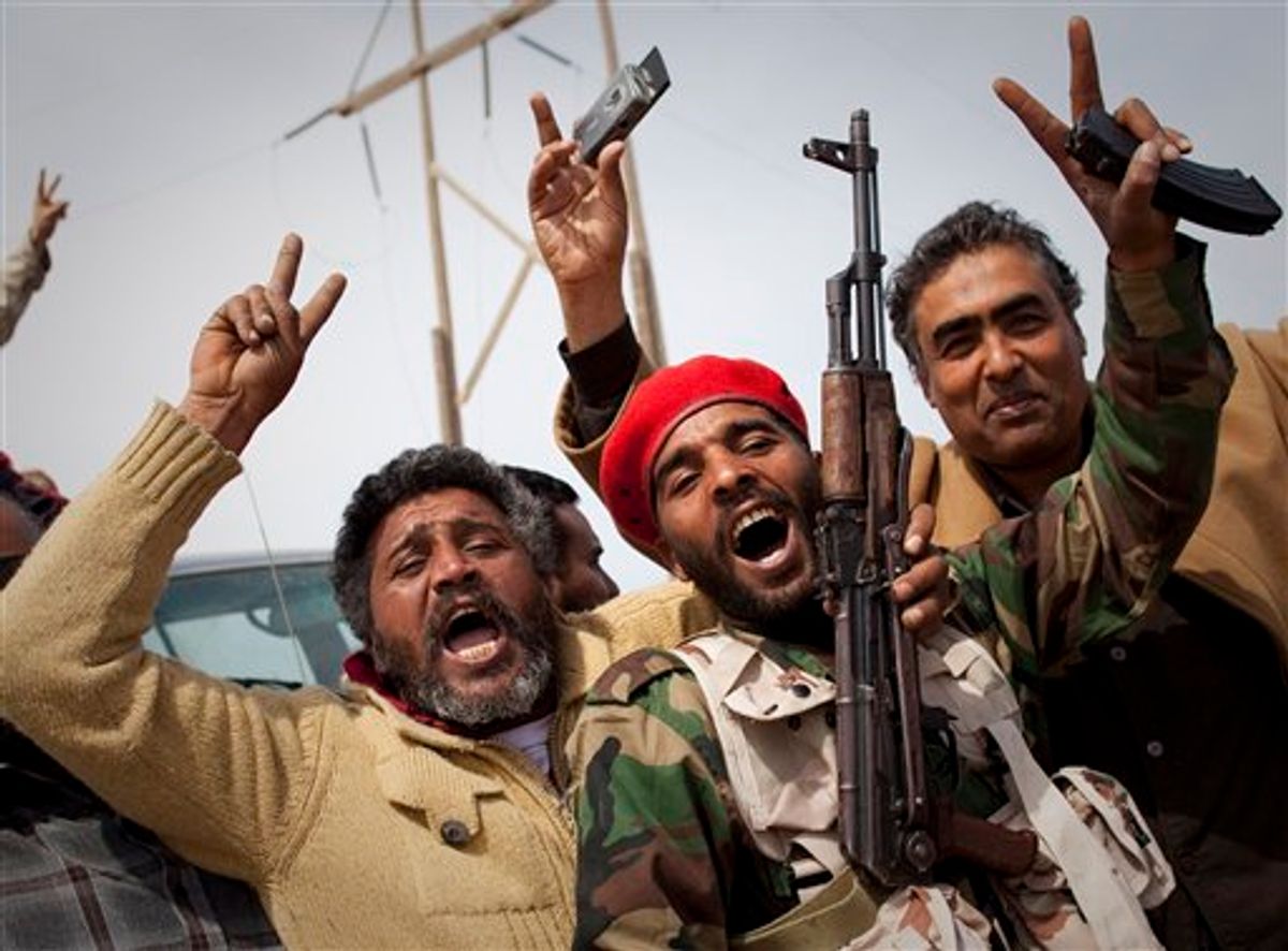 Libyan rebels jubilate on a checkpoint in Al-Egila, east of Ras Lanuf, eastern Libya, Sunday, March 27, 2011. The rebels claim that they have entered Ras Lanuf. (AP Photo/Anja Niedringhaus) (AP)