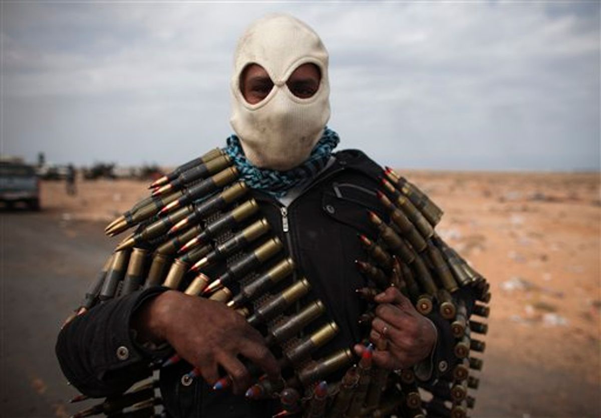 A Libyan volunteer carries ammunition on the outskirts of the eastern town of Ras Lanouf, Libya, Thursday, March 10, 2011. Government forces drove hundreds of rebels from a strategic oil port with rockets and tank shells on Thursday, significantly expanding Moammar Gadhafi's control of Libya. (AP Photo/Tara Todras-Whitehill) (AP)