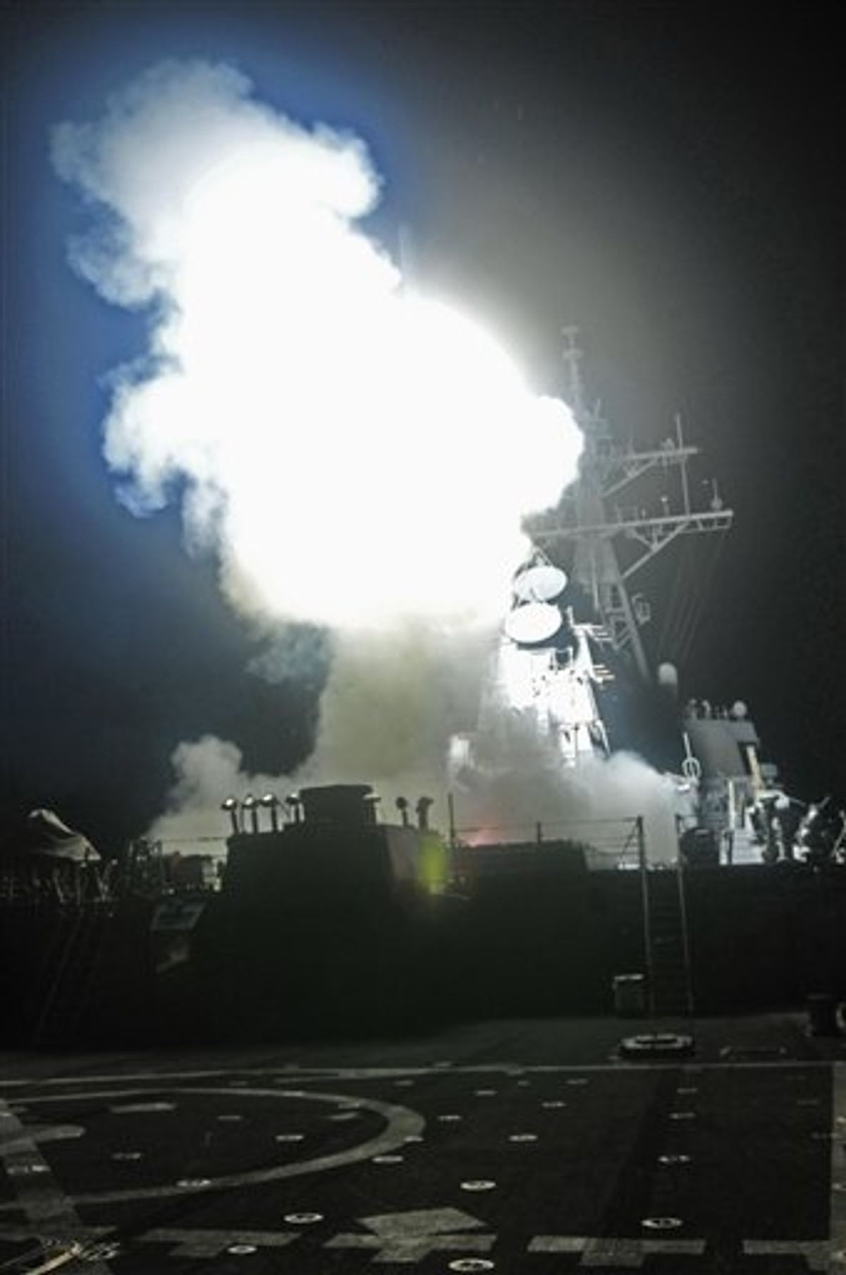 This Saturday, March 19, 2011 photo provided by the U.S. Navy shows the Arleigh Burke-class guided-missile destroyer USS Barry (DDG 52) as it launches a Tomahawk missile in support of Operation Odyssey Dawn from the Mediterranean Sea . The U.S. fired more than 100 cruise missiles from the sea while French fighter jets targeted Moammar Gadhafi's forces from the air on Saturday, launching the broadest international military effort since the Iraq war in support of an uprising that had seemed on the verge of defeat. (AP Photo/U.S. Navy, MC3 Jonathan Sunderman) (AP)
