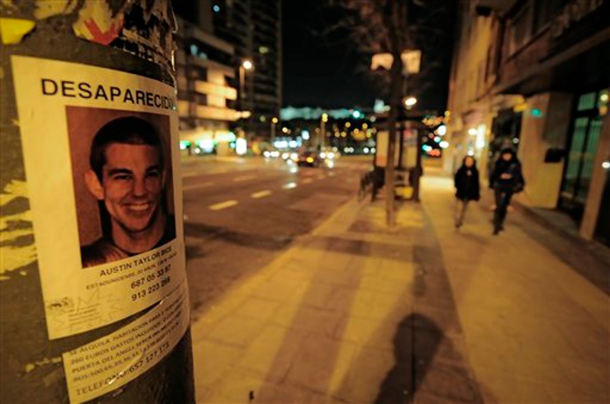 A poster of missing U.S. student Austin Bice, is stuck to a lamp post , near to La Riviera Discotheque,  as people walk past on the street   in  Madrid, Monday March 7, 2011. Police, family and friends have stepped up a search for the San Diego State University exchange student who went missing after visiting a nightclub in Madrid more than a week ago.(AP Photo/Alvaro Barrientos) (AP)