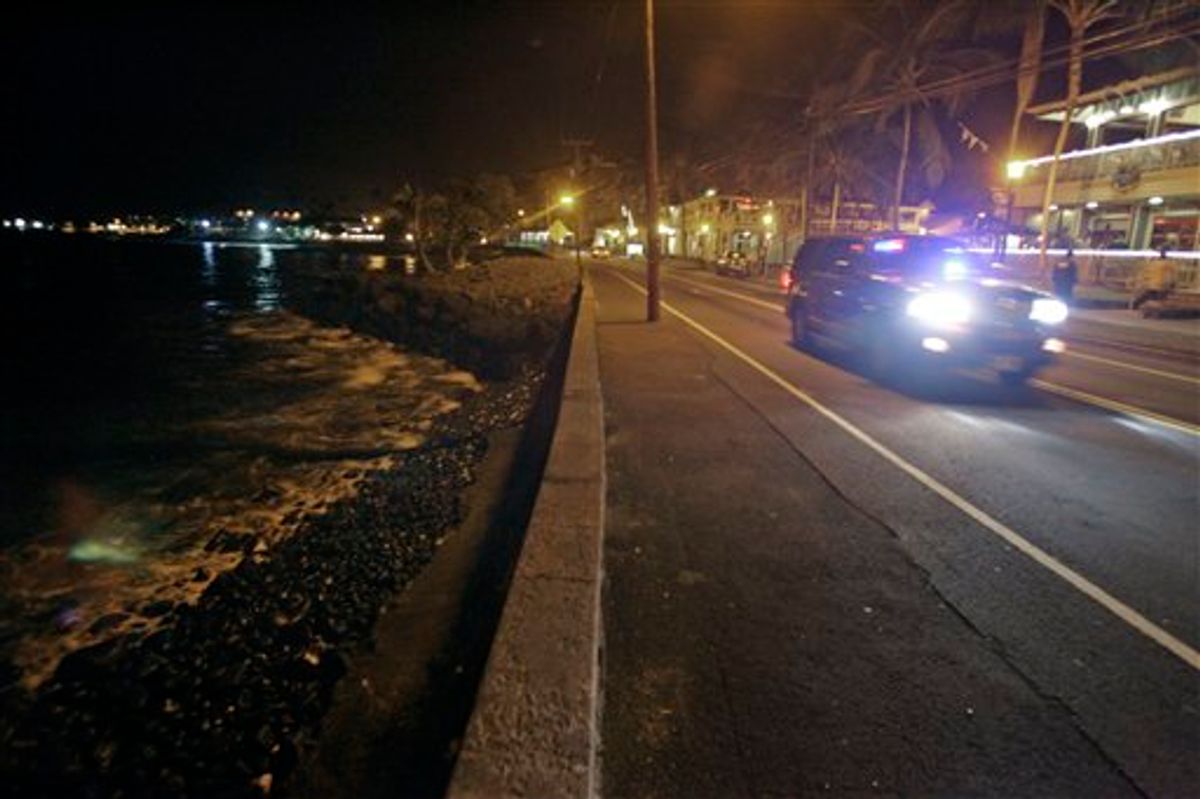 A police car drives along empty Ali'i Drive in Kailua-Kona, Hawaii, Thursday, March 10, 2011.  A tsunami warning following an earthquake in Japan forced the evacuation of coastal areas of the island. Tsunami waves spawned by a massive earthquake in Japan have hit Hawaii early Friday. The Pacific Tsunami Warning Center says Kauai was the first island hit by the tsunami, which was quickly sweeping through the Hawaiian Island chain. Officials predicted Hawaii would experience waves up to 6 feet.  (AP Photo/Chris Stewart) (AP)
