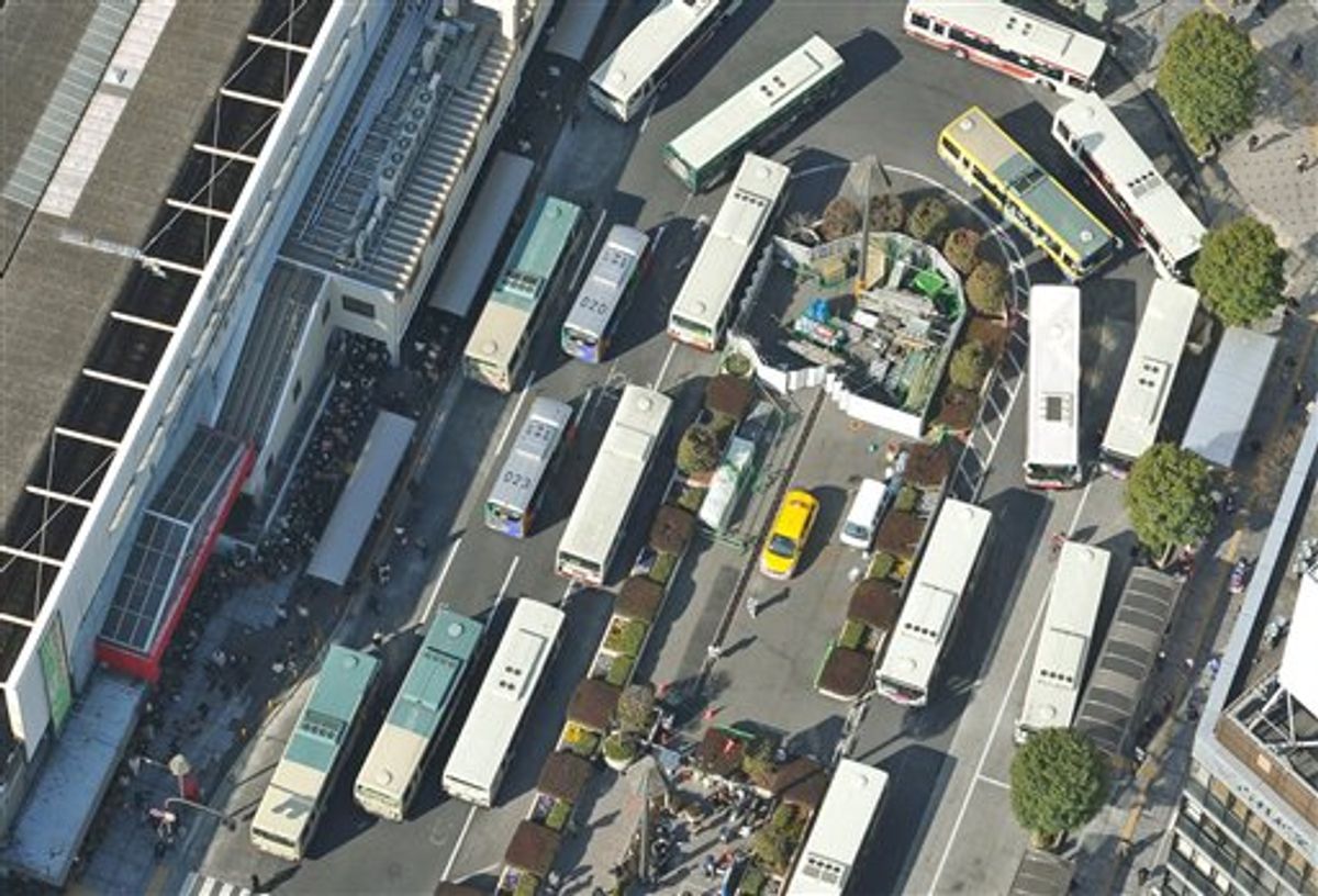 Buses crowd at bus terminal in Musashino, on the outskirts of Tokyo Monday, March 14, 2011.  In Tokyo and elsewhere, authorities began rolling blackouts to conserve power as they tried desperately to stabilize the nuclear reactors at risk of meltdown in the aftermath of the earthquake and tsunami. (AP Photo/Kyodo News) JAPAN OUT, MANDATORY CREDIT, NO SALES IN CHINA, HONG  KONG, JAPAN, SOUTH KOREA AND FRANCE (AP)