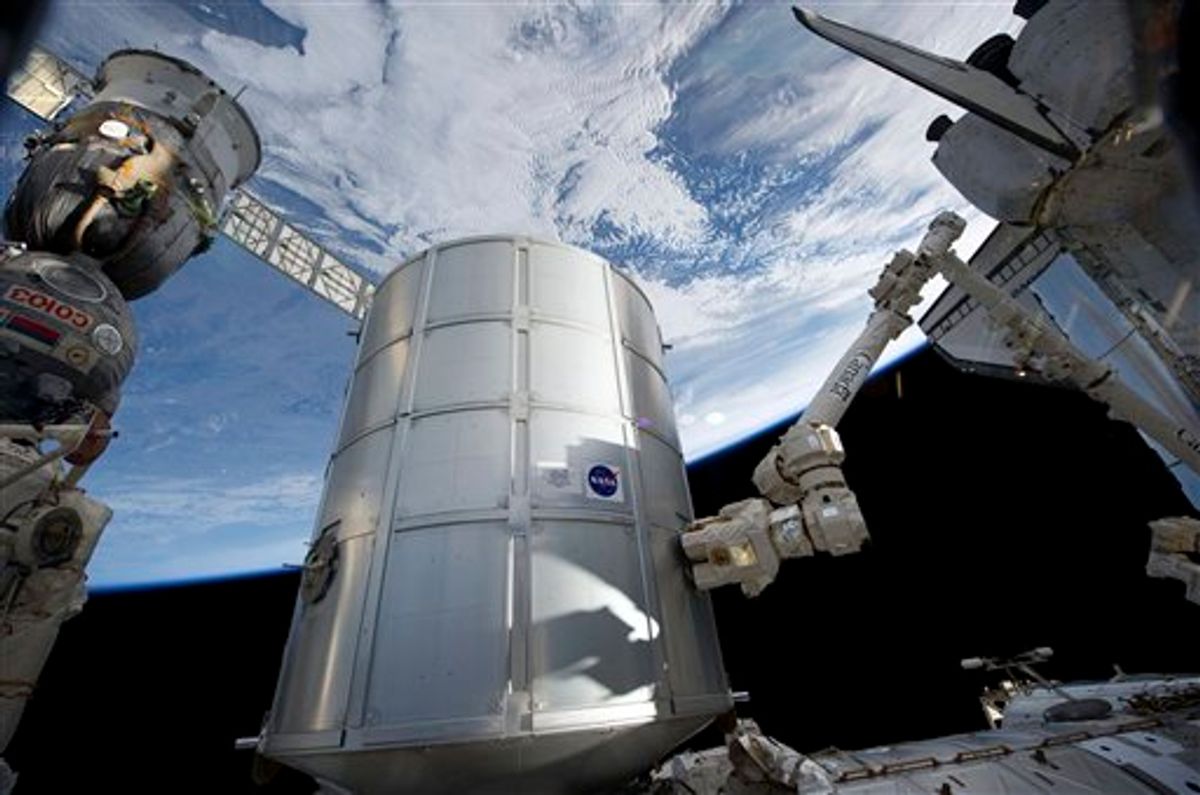 In this image provided by NASA the Italian-built Permanent Multipurpose Module in the grasp of the International Space Station's Canadarm2 is being transferred from space shuttle Discovery's payload bay to be permanently attached to the Earth-facing port of the station's Unity node Tuesday March 1, 2011. Earth's horizon and the blackness of space provide the backdrop for the scene. (AP Photo/NASA)    (AP)