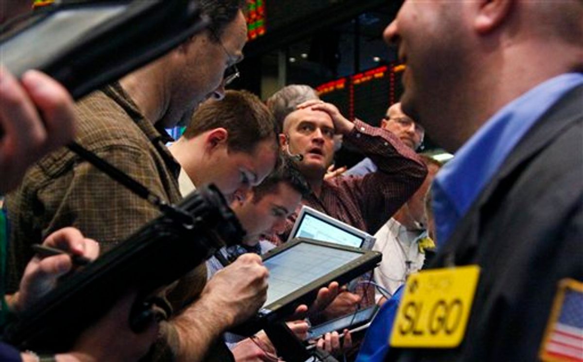 Traders of crude oil and natural gas react during early trading at the New York Mercantile Exchange on Friday, March 11, 2011. The economic fallout from a massive earthquake that struck off the east coast of Japan dipped oil below $100 for the first time this month. (AP Photo/Bebeto Matthews) (AP)
