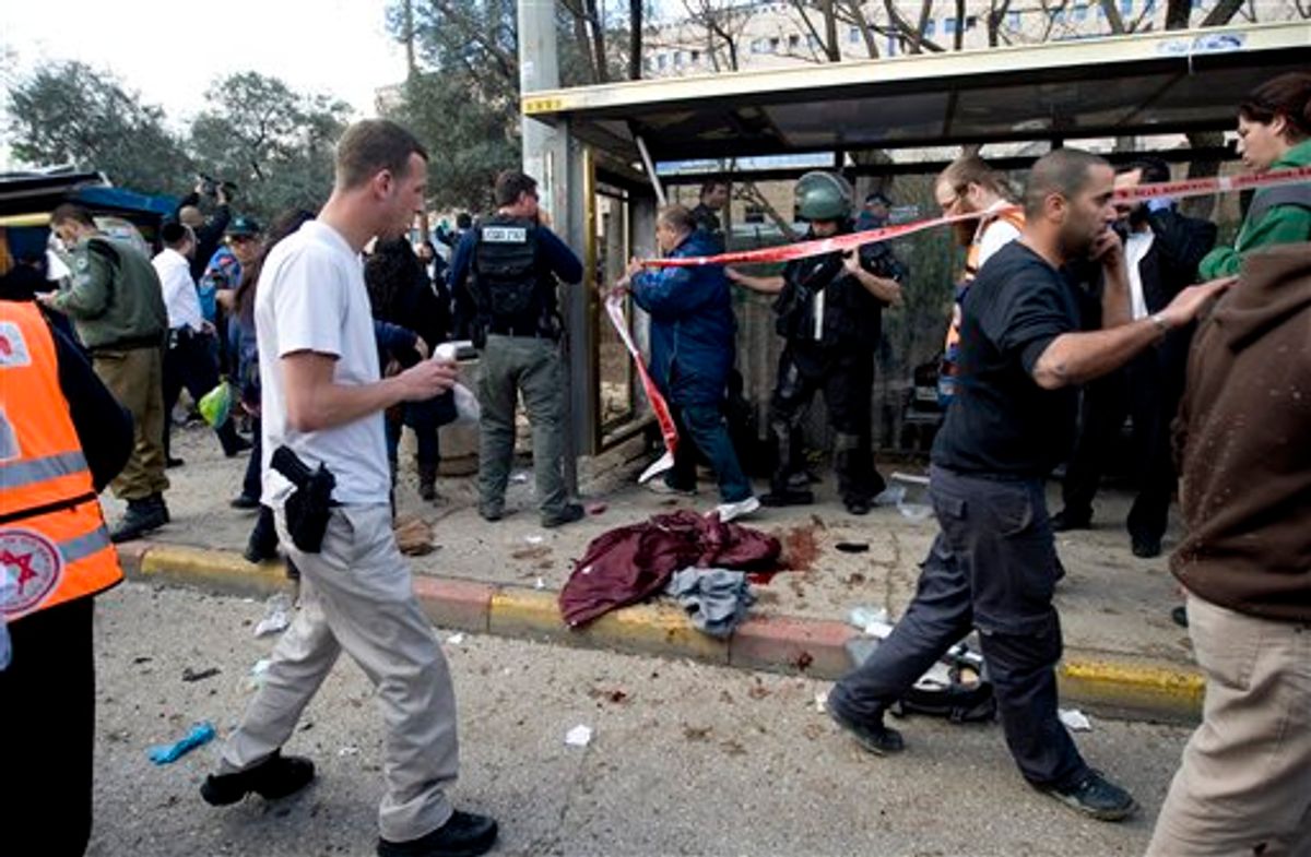Israel Rescue workers and paramedics work next to a pool of blood following an explosion at a bus stop in Jerusalem, Wednesday, March 23, 2011. A bomb exploded near a crowded bus, wounding at least eight people in what appeared to be the first militant attack in the city in several years. (AP Photo/Ariel Schalit) (AP)