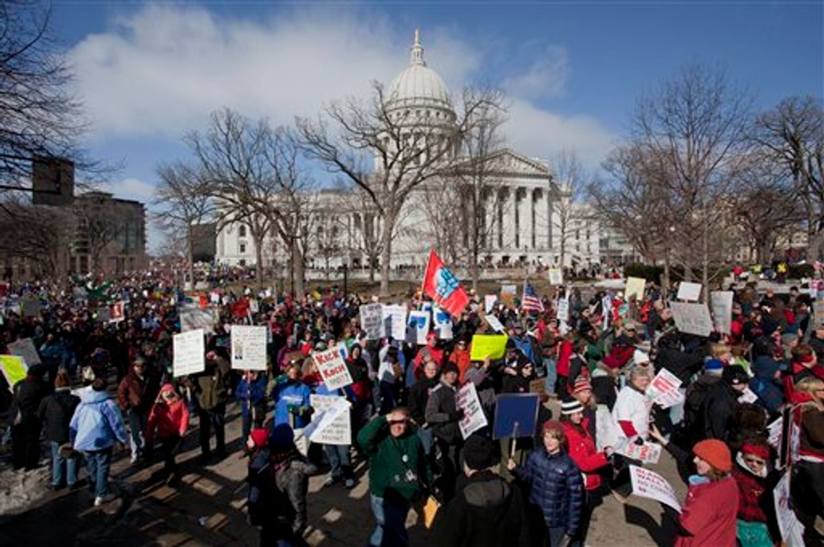 Thousands of pro-labor protesters rallied at the Wisconsin Capitol Saturday, March 12, 2011, in Madison, Wis., vowing to fight back after the state's Republican governor signed into law a controversial bill that eliminates most union rights for public employees.(AP Photo/Morry Gash) (AP)