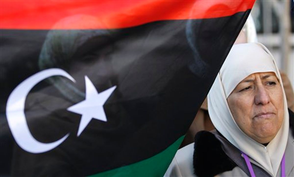 Anti-Gadhafi protestors Kadija Sherif, right, and Hana Benghalbon, background, take part in a demonstration at the Libyan Embassy in Washington, Tuesday, March 1, 2011. (AP Photo/Luis M. Alvarez) (AP)