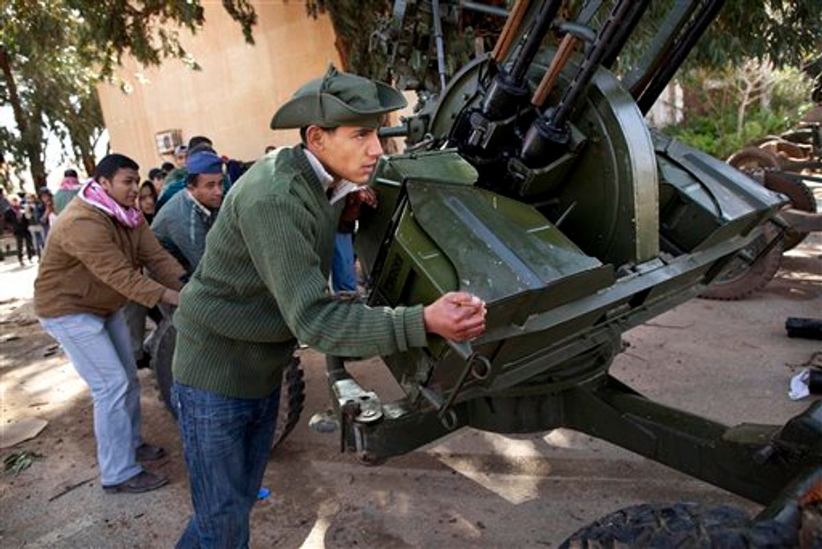 New Libyan rebel recruits from the forces against Libyan leader Moammar Gadhafi  push an anti-aircraft gun at a military base in Benghazi, eastern Libya, Tuesday, March 1 , 2011. (AP Photo/Kevin Frayer) (AP)