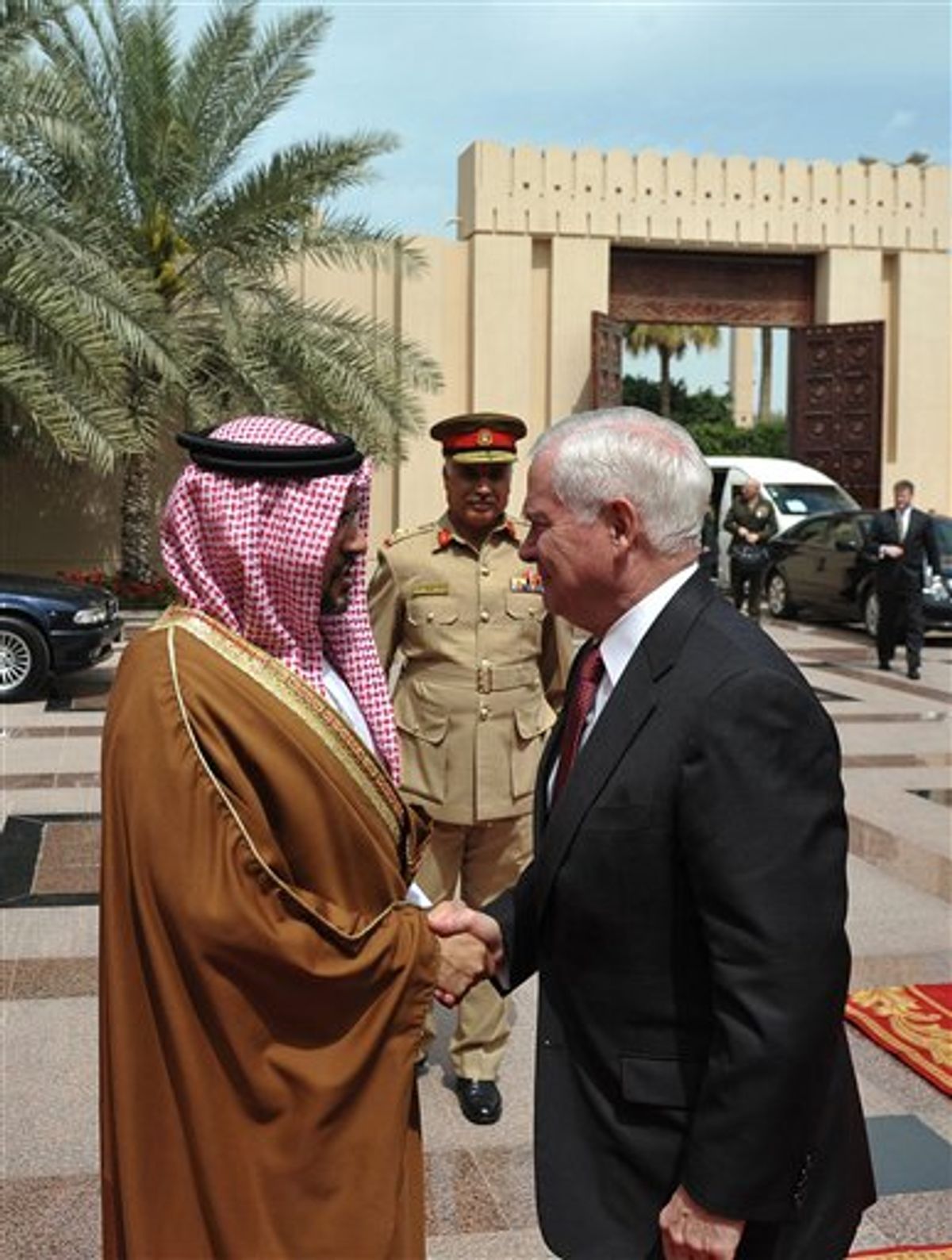 U.S. Defense Secretary Robert Gates, right, is greeted by Bahrain's Crown Prince Salman bin Hamad al-Khalifa as he arrives for a meeting at Al-Zahar Palace in Manama Saturday, March 12, 2011. Gates is meeting in Bahrain with the kingdom's top rulers, who are facing growing demands for more political freedom.  (AP Photo/ Mandal Ngan, pool) (AP)