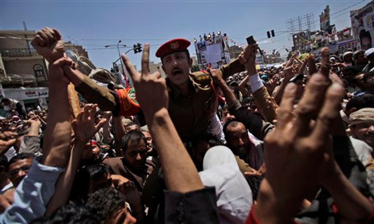 A Yemeni army officer carried by anti-government protestors during a demonstration demanding the resignation of Yemeni President Ali Abdullah Saleh, in Sanaa,Yemen, Wednesday, March 23, 2011. Yemen's parliament enacted sweeping emergency laws Wednesday after the country's embattled president asked for new powers of arrest, detention and censorship to quash a popular uprising demanding his ouster. (AP Photo/Muhammed Muheisen) (AP)
