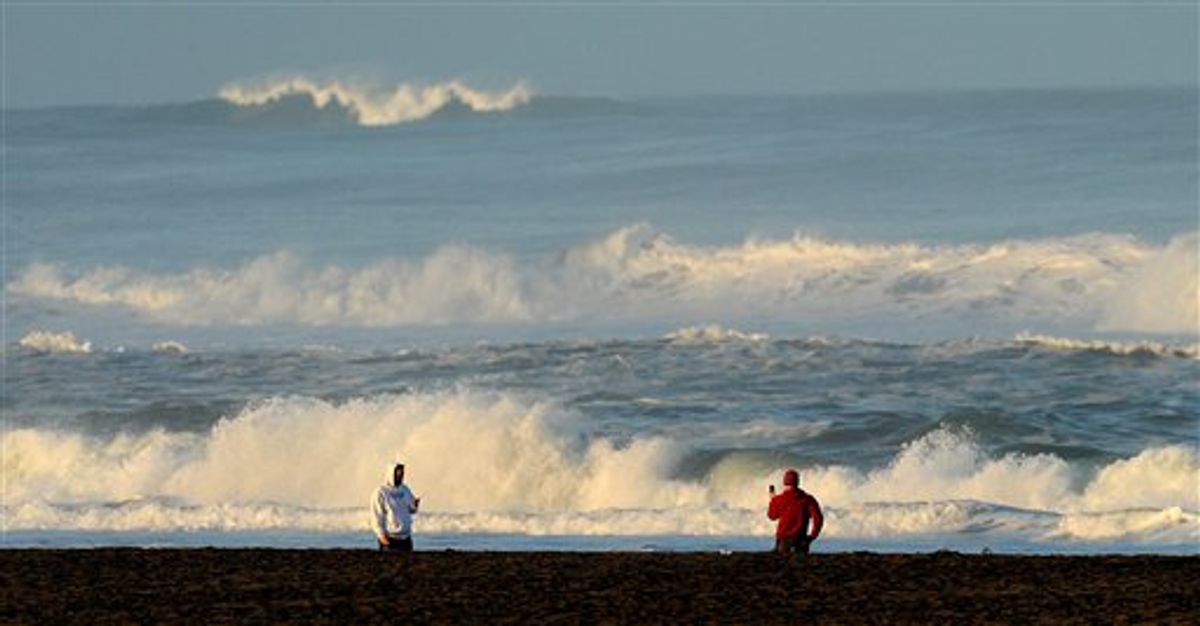 With a tsunami warning in effect for Northern California, two men watch the waves at San Francisco's Ocean Beach on Friday, March 11, 2011. The tsunami warnings came after a 8.9-magnitude earthquake struck Japan. (AP Photo/Noah Berger) (AP)