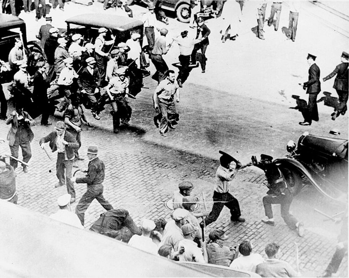 Striking teamsters armed with pipes clash with police in the streets of Minneapolis, June 1934.