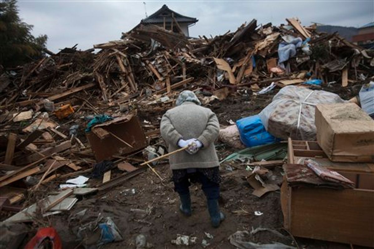 An elderly Japanese woman searches for her belongings in the March 11 earthquake and tsunami-destroyed town of Rikuzentakata, northeastern Japan, Monday, March 21, 2011. (AP Photo/David Guttenfelder) (AP)