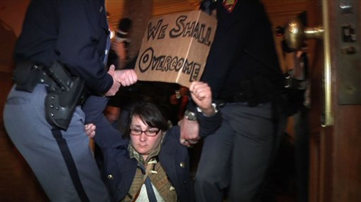 In this image from video, police carry off a demonstrator during a protest at the State Capitol, Thursday, March 10, 2011, in Madison, Wis. Police carried dozens of protesters from a hallway leading to the Wisconsin Assembly on Thursday as Democratic representatives pounded on the locked door of the chamber, demanding to be let in to the room where a vote was scheduled on an explosive bill that would take away public workers' collective bargaining rights.  (AP Photo/Robert Ray) (AP)