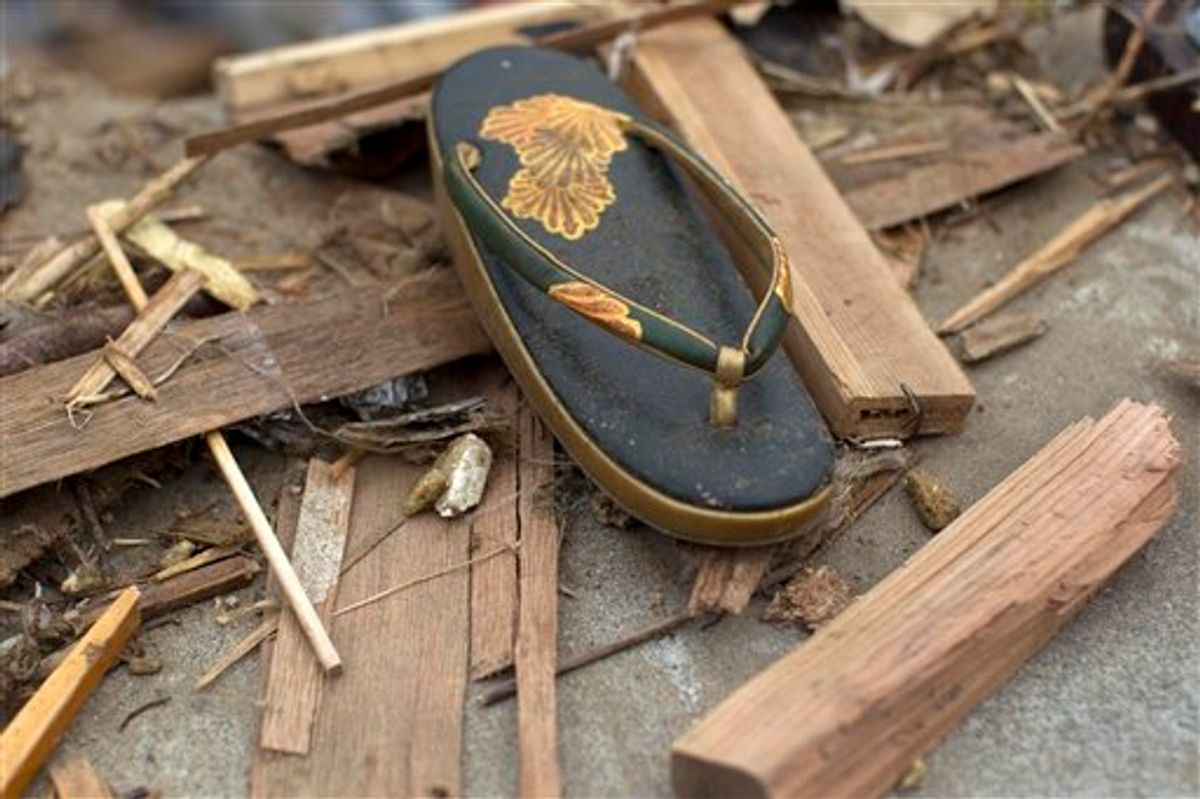 A traditional Japanese sandal, worn with formal kimono dress, lies in the rubble in the earthquake and tsunami destroyed town of Onagawa, Miyagi Prefecture, northeastern Japan Sunday, March 20, 2011. (AP Photo/David Guttenfelder) (AP)