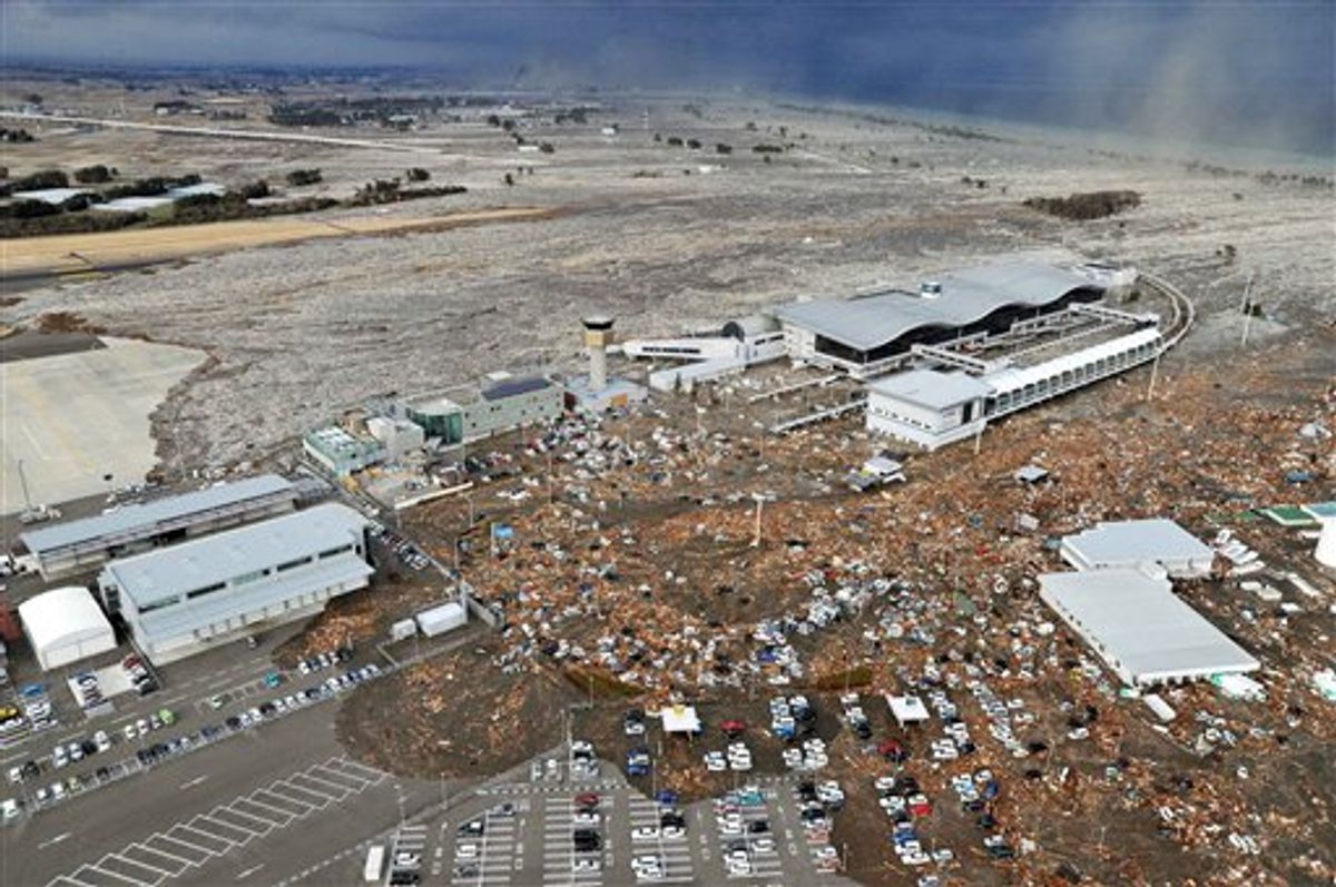 Tarmac, parking lot and surrounding area are covered with mud and debris carried by tsunami at Sendai Airport in Sendai, Miyagi Prefecture (state) after Japan was struck by a strong earthquake off its northeastern coast Friday, March 11, 2011. (AP Photo/Kyodo News) JAPAN OUT, MANDATORY CREDIT, FOR COMMERCIAL USE ONLY IN NORTH AMERICA (AP)
