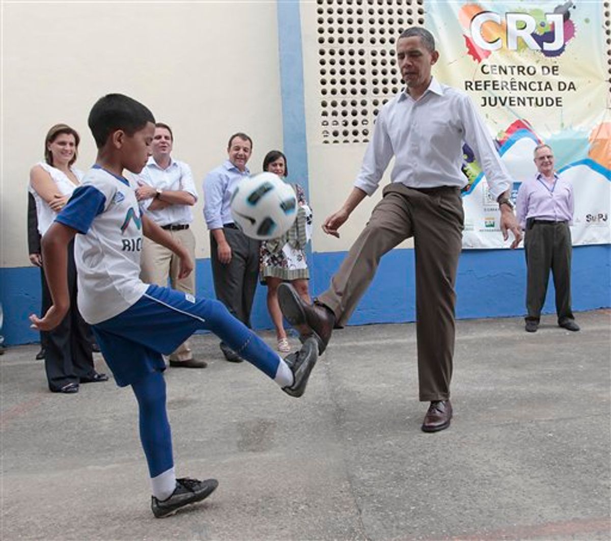 U.S. President Barack Obama practices his soccer dribbling abilities as he plays with local children during his tour of the Ciudad de Deus Favela in Rio de Janeiro, Brazil, Sunday, March 20, 2011. (AP Photo/Pablo Martinez Monsivais) (AP)