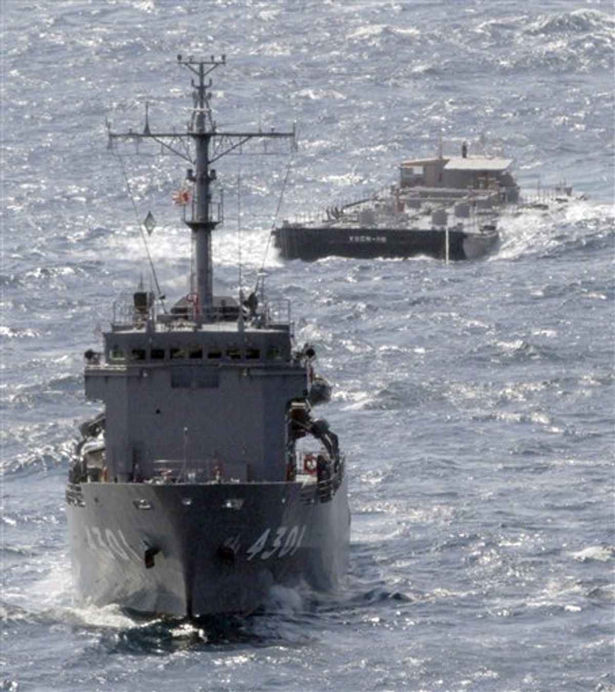 U.S. Navy's barge YOGN-115, back, is towed by Japan's Maritime Self-Defense Force's multi purpose support ship off the coast of Isumi, Chiba Prefecture, Japan, Saturday, March 26, 2011. The barge carrying 1.04 million liters (275,000 gallons) of fresh water departed Commander, Fleet Activities Yokosuka (CFAY) Friday to support cooling efforts at the tsunami-damaged Fukushima Dai-ichi nuclear power plant. (AP Photo/Yomiuri Shimbun, Yasushi Kanno) JAPAN OUT, MANDATORY CREDIT (AP)