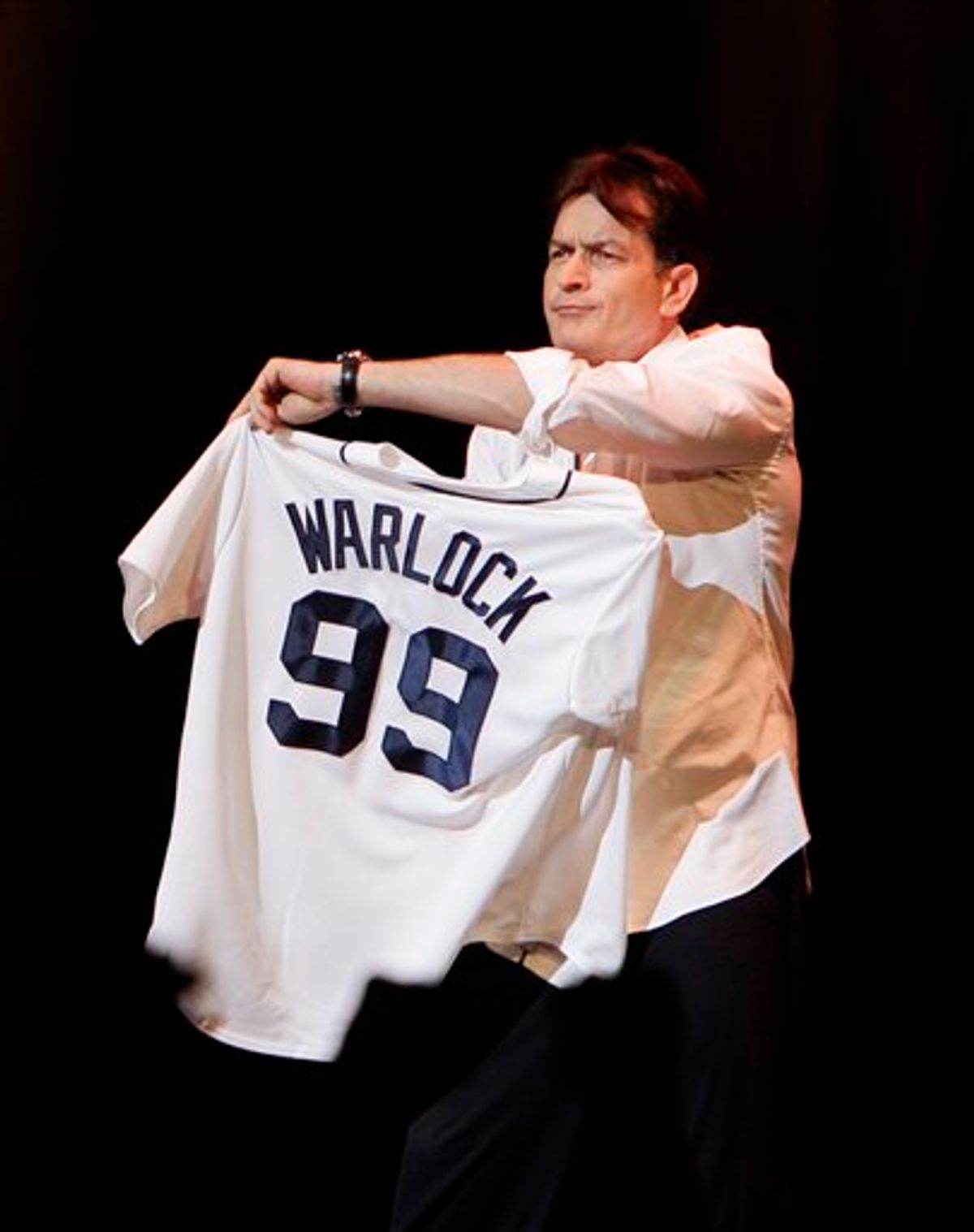 Actor Charlie Sheen shows off his Detroit Tigers jersey during his performance at the Fox Theatre in Detroit, Saturday, April 2, 2011. Promising "the real story," the 45-year-old former "Two and a Half Men" star hit the road for a month-long, 20-city variety show tour, with the first stop Saturday's sold-out show in Detroit. (AP Photo/Carlos Osorio) (AP)