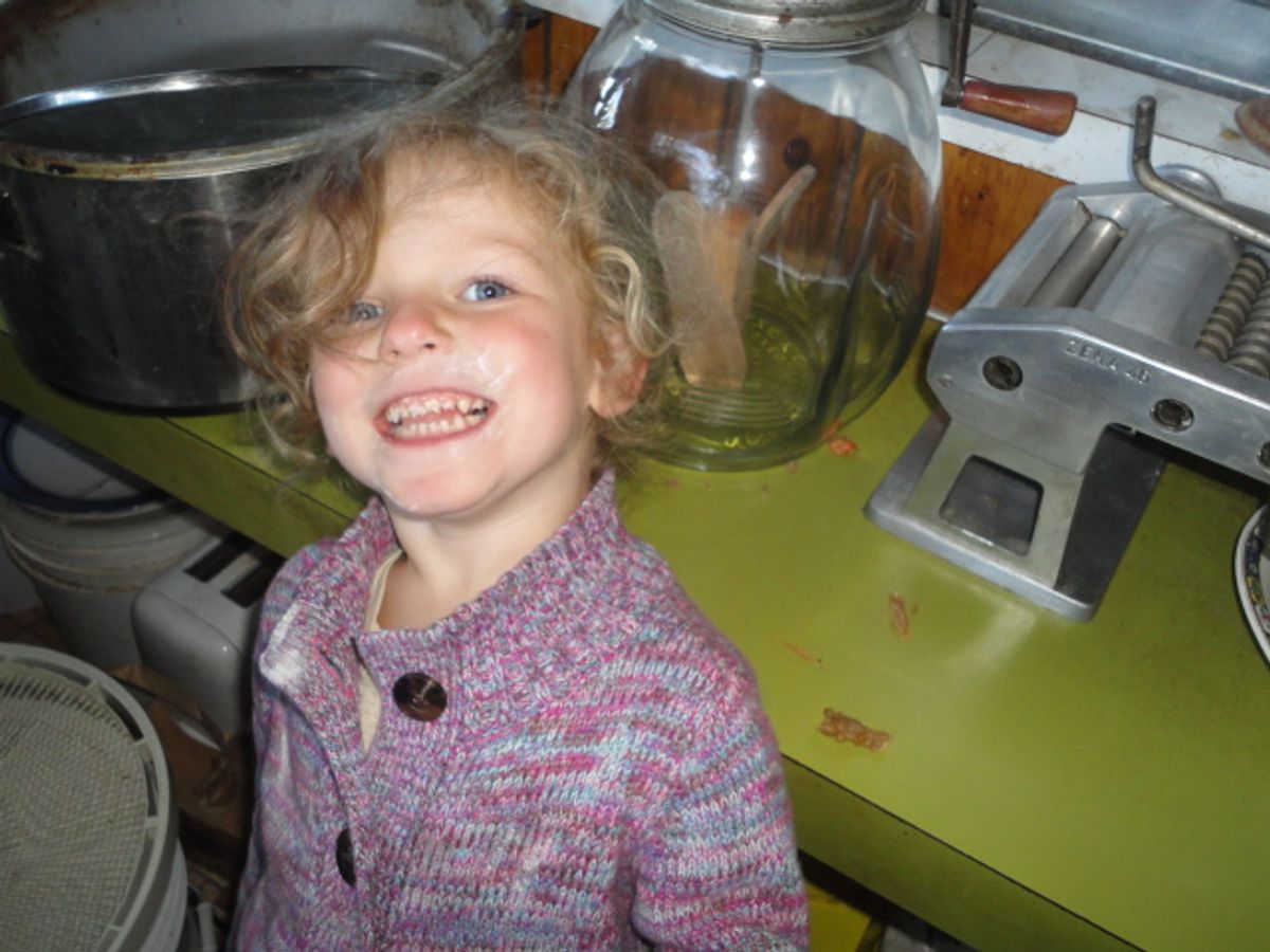 3-year-old Zoie helps out in the kitchen at McKenzie River Organic Farm.