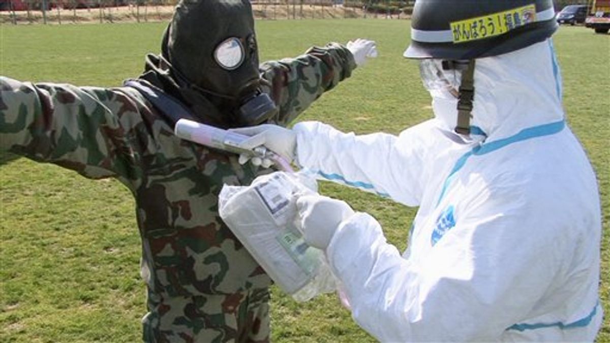 In this April 12, 2011 photo released by the Japan Defense Agency via Kyodo News, a Japanese soldier is tested for radiation exposure at J-Village, a soccer training complex now serving as an operation base for those battling Japan's worst nuclear disaster, northeastern Japan. The sports complex is about about 20 kilometers (12 miles) from the Fukushima Dai-ichi nuclear plant. (AP Photo/Japan Defense Agency via Kyodo News) JAPAN OUT, MANDATORY CREDIT, NO LICENSING IN CHINA, HONG KONG, JAPAN, SOUTH KOREA AND FRANCE  (AP)