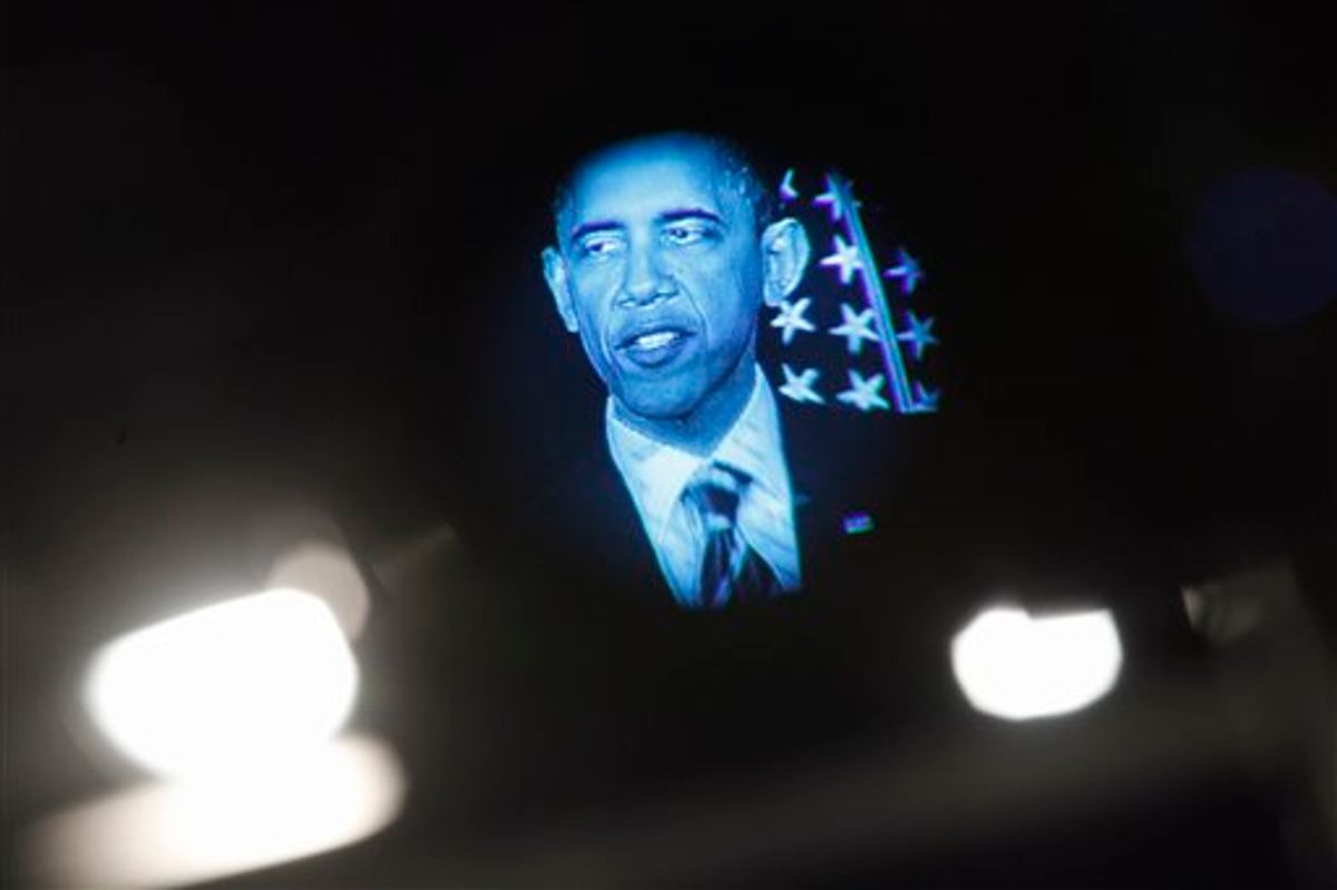 President Barack Obama is seen in a television monitor as he outlines his fiscal policy during an address at George Washington University in Washington, Wednesday, April 13, 2011.  (AP Photo/Charles Dharapak) (AP)