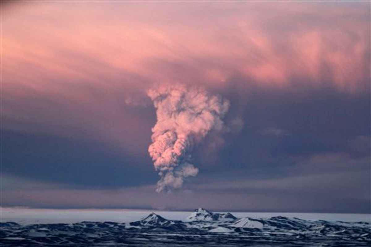 In this photo taken on Saturday, May 21, 2011,  smoke plumes from the Grimsvotn volcano, which lies under the Vatnajokull glacier, about 120 miles, (200 kilometers) east of the capital, Rejkjavik, which began erupting Saturday for the first time since 2004.  Iceland closed its main international airport and canceled domestic flights Sunday as a powerful volcanic eruption sent a plume of ash, smoke and steam 12 miles (20 kilometers) into the air. (AP Photo/Jon Gustafsson) ICELAND OUT (AP)