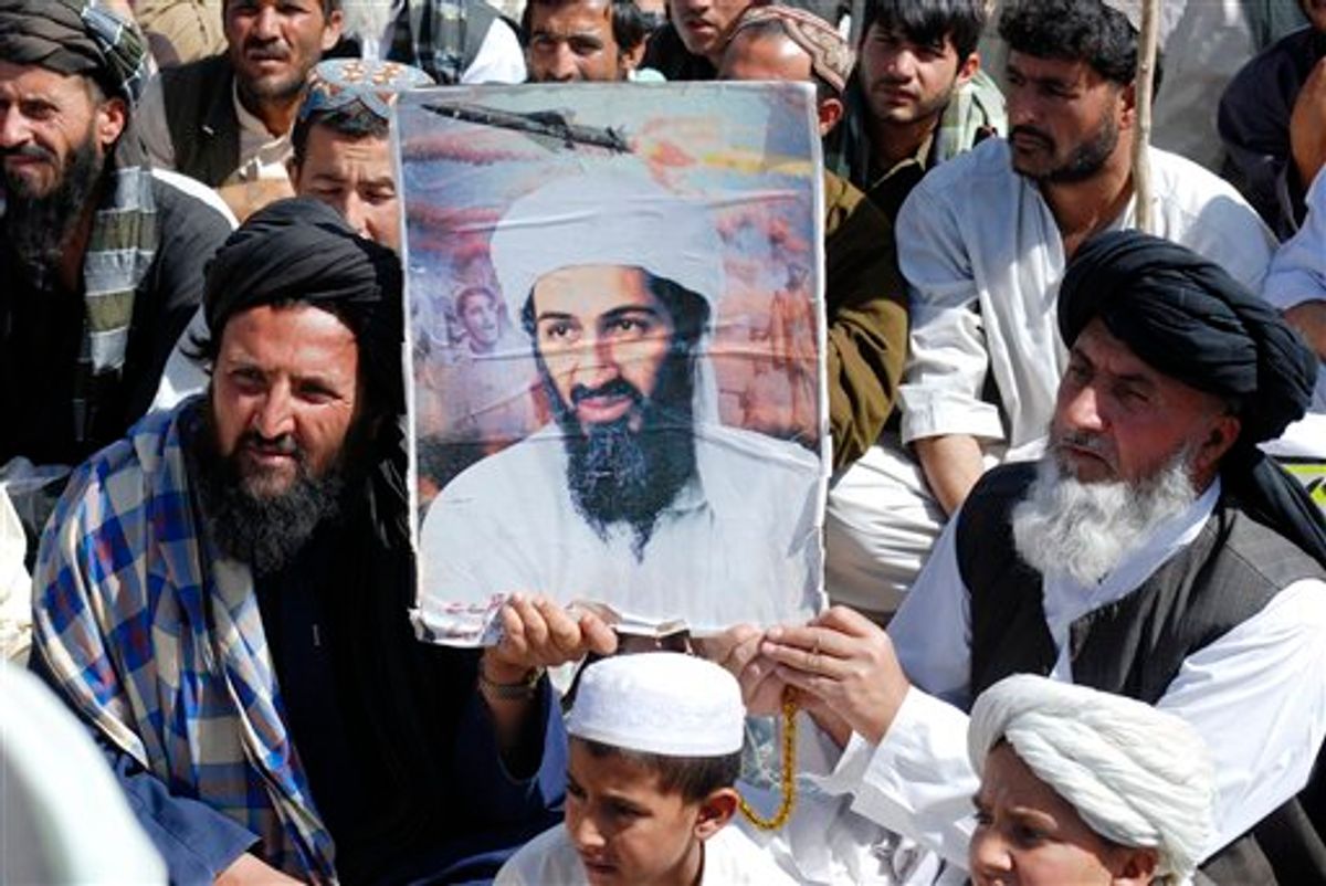 Supporters Pakistani religious party Jamiat Ulema-e-Islam hold al-Qaida leader Osama bin Laden's picture during a rally, in Kuchlak, 25 kilometers (16 miles) north of Quetta, Pakistan on Friday, May 6, 2011. One of three wives living with Osama bin Laden has told Pakistani interrogators she had been staying in the al-Qaida chief's hideout for six years without leaving its upper floors, a Pakistani intelligence official said Friday.(AP Photo/Arshad Butt) (AP)