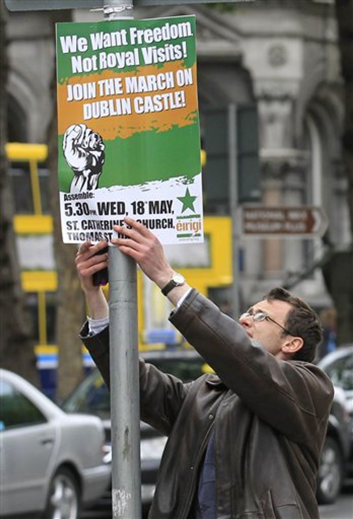 A protester puts up a placard to protest at the visit by Britain's Queen Elizabeth II to Ireland, Monday, May, 16, 2011.  Queen Elizabeth II begins a four day visit to Ireland on Tuesday for the first time since Irish Independence.  (AP Photo/Peter Morrison) (AP)