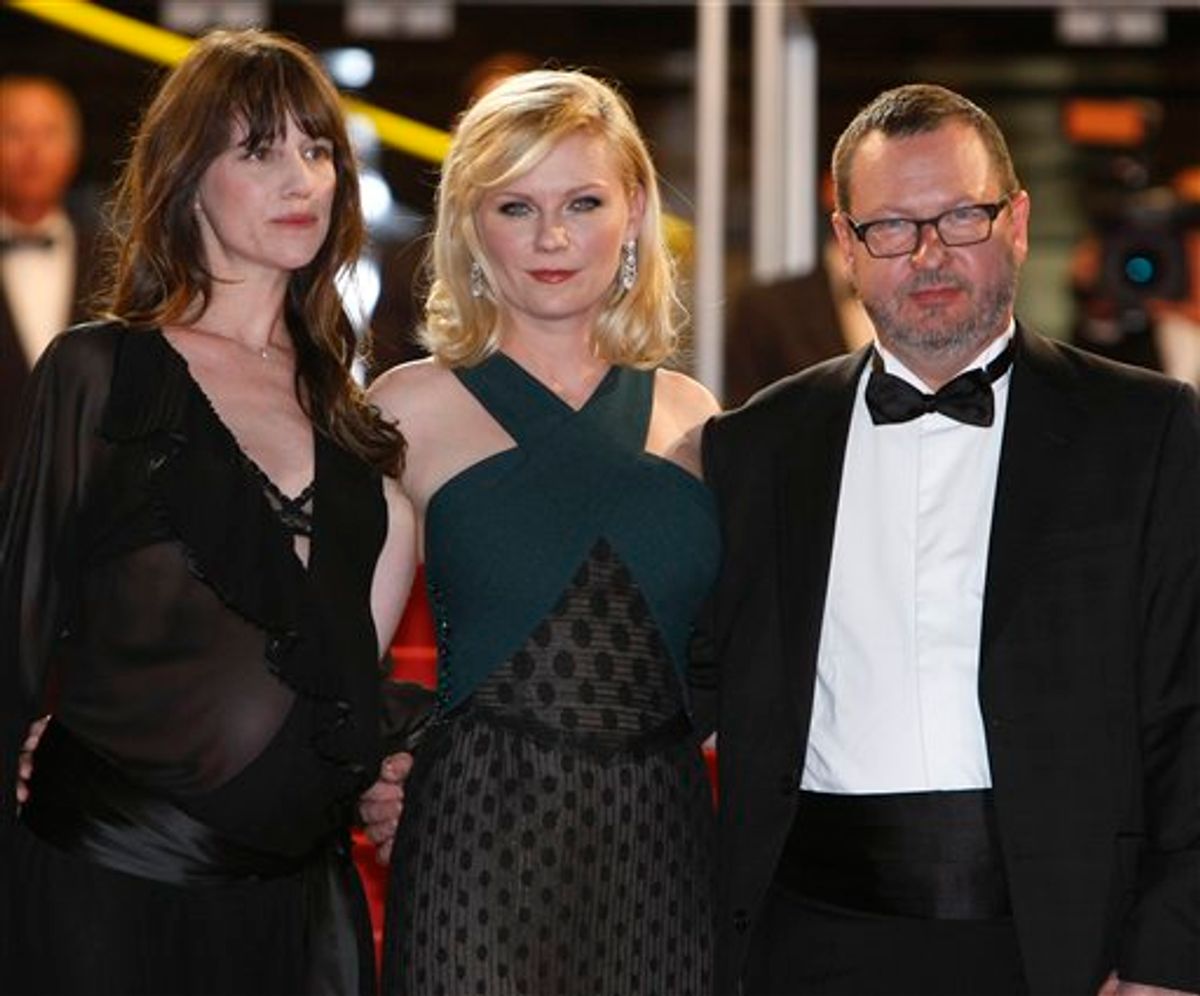 From left, actresses Charlotte Gainsbourg, Kirsten Dunst and director Lars Von Trier arrive for the screening of Melancholia at the 64th international film festival, in Cannes, southern France, Wednesday, May 18, 2011. (AP Photo/Francois Mori) (AP)