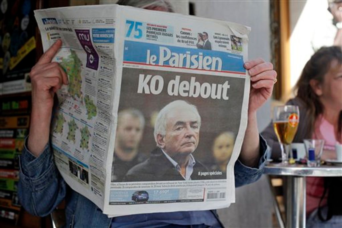 A woman reads the French newspaper "Le Parisien" headlining on IMF head arrest, in Paris, Tuesday May 17, 2011. Allegations of sexual assault in a New York hotel have torn France's presidential race asunder and savaged the reputation of the suave and self-assured Dominique Strauss-Kahn, chief of the International Monetary Fund. The 62-year-old Strauss-Kahn has topped French opinion polls for months as the man most likely to become this nation's next president, consistently outshining the little-loved conservative incumbent, Nicolas Sarkozy. Headline reads: Standing K.O. (AP Photo/Thibault Camus) (AP)