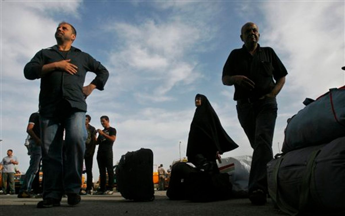 Palestinians wait next to their belongings before crossing into Egypt through the Rafah border crossing, southern Gaza Strip, Thursday, May 26, 2011. Egypt's decision to end its blockade of Gaza by opening the only crossing to the Hamas-ruled Palestinian territory this weekend could ease the isolation of 1.4 million Palestinians there. (AP Photo/Eyad Baba) (AP)
